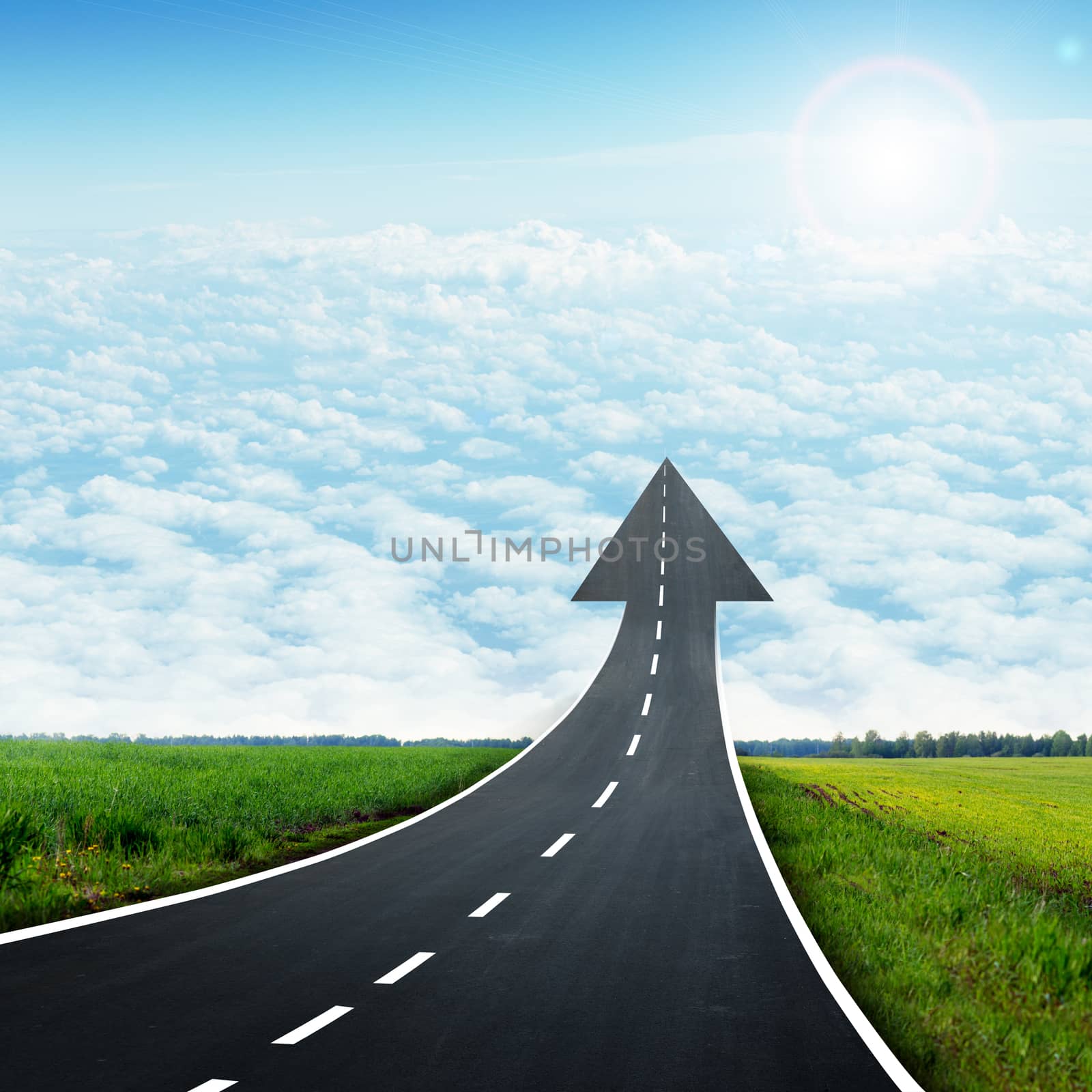 Highway road going up llike arrow in sky with sun and clouds