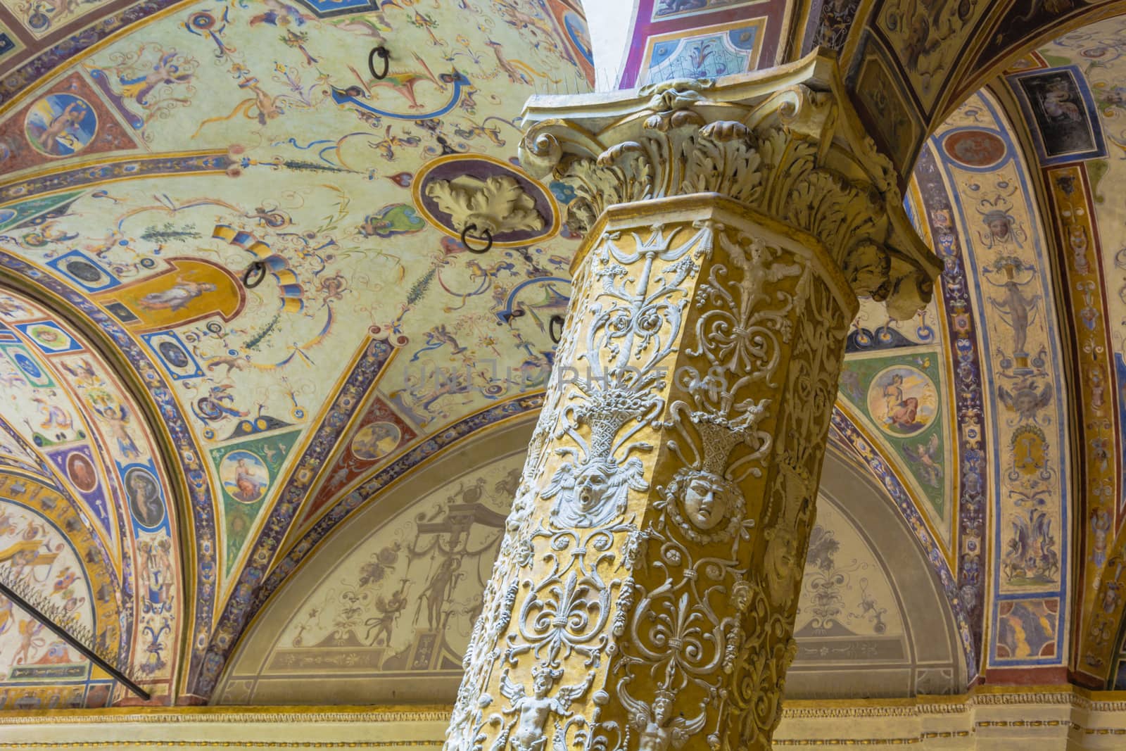 Detail of a decorated column and ceiling in the Palazzo della Signoria first Courtyard