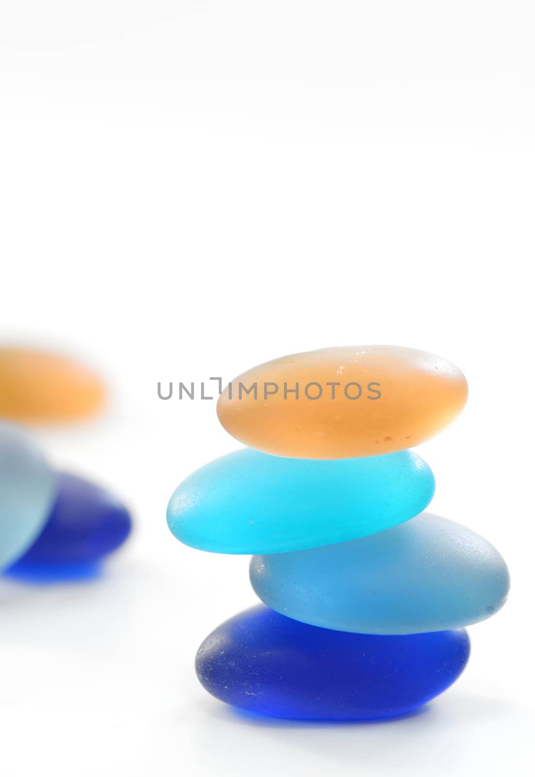 Pyramid of glass stones isolated on white background