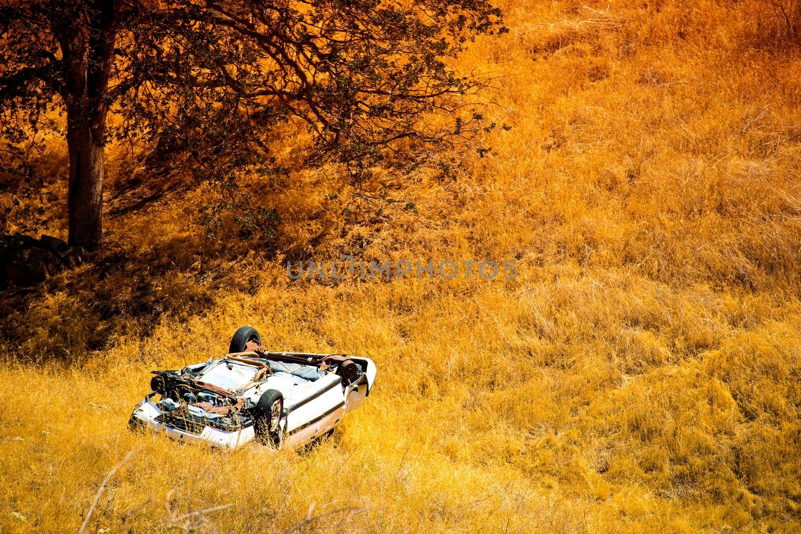 Rollover Compact Car Crash. White Crashed Car in the Mountain Road Ditch in California, USA. Traffic Accident.