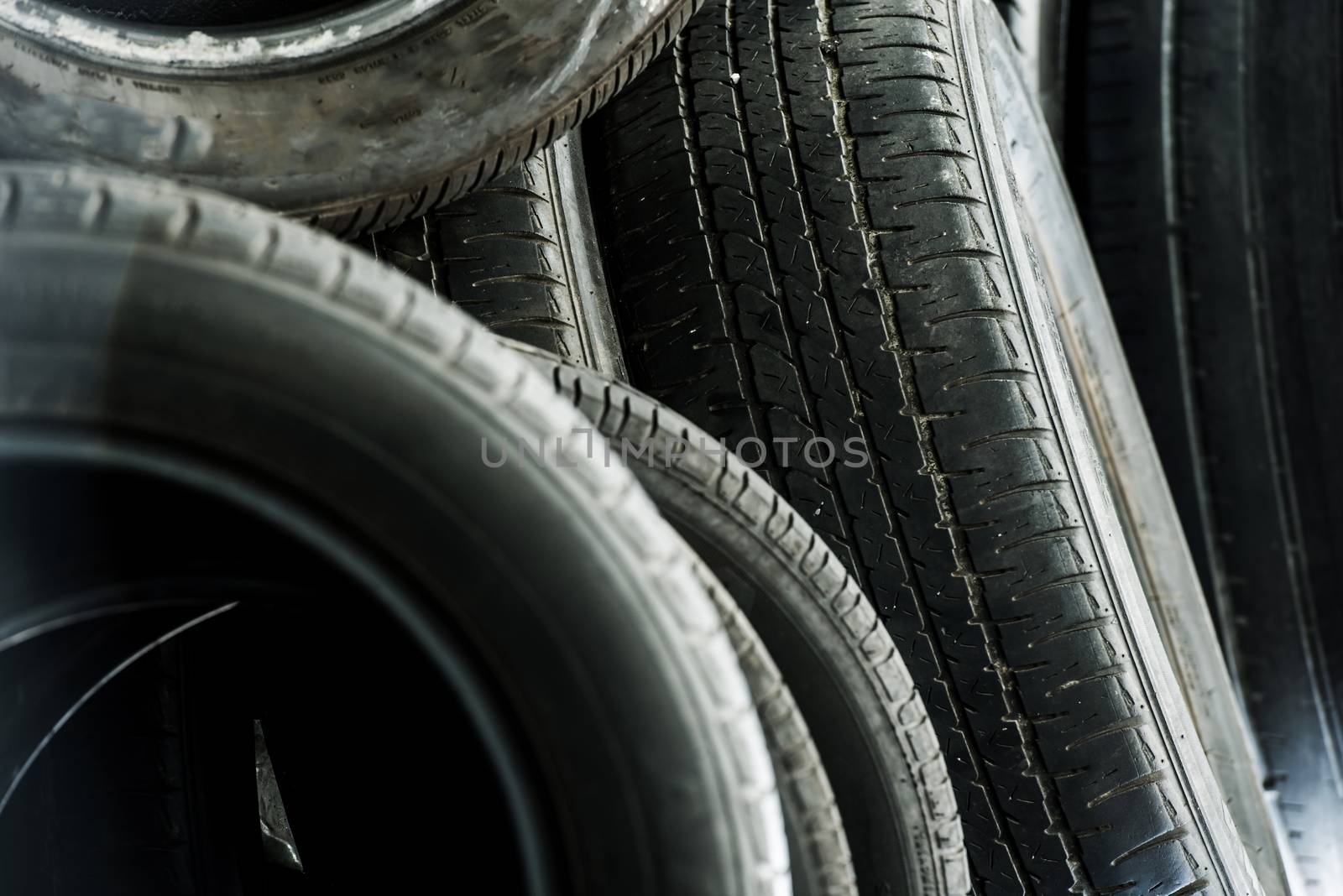 Old Used Tires Pile. Pile of Used Car Tires Closeup Photo.