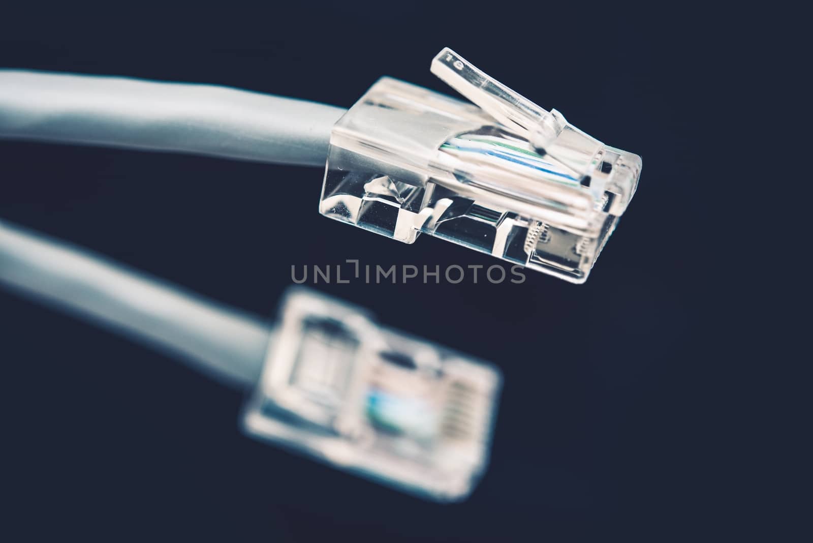 Network Cable Grey Cord with Connector RJ45 on Dark Blue Background