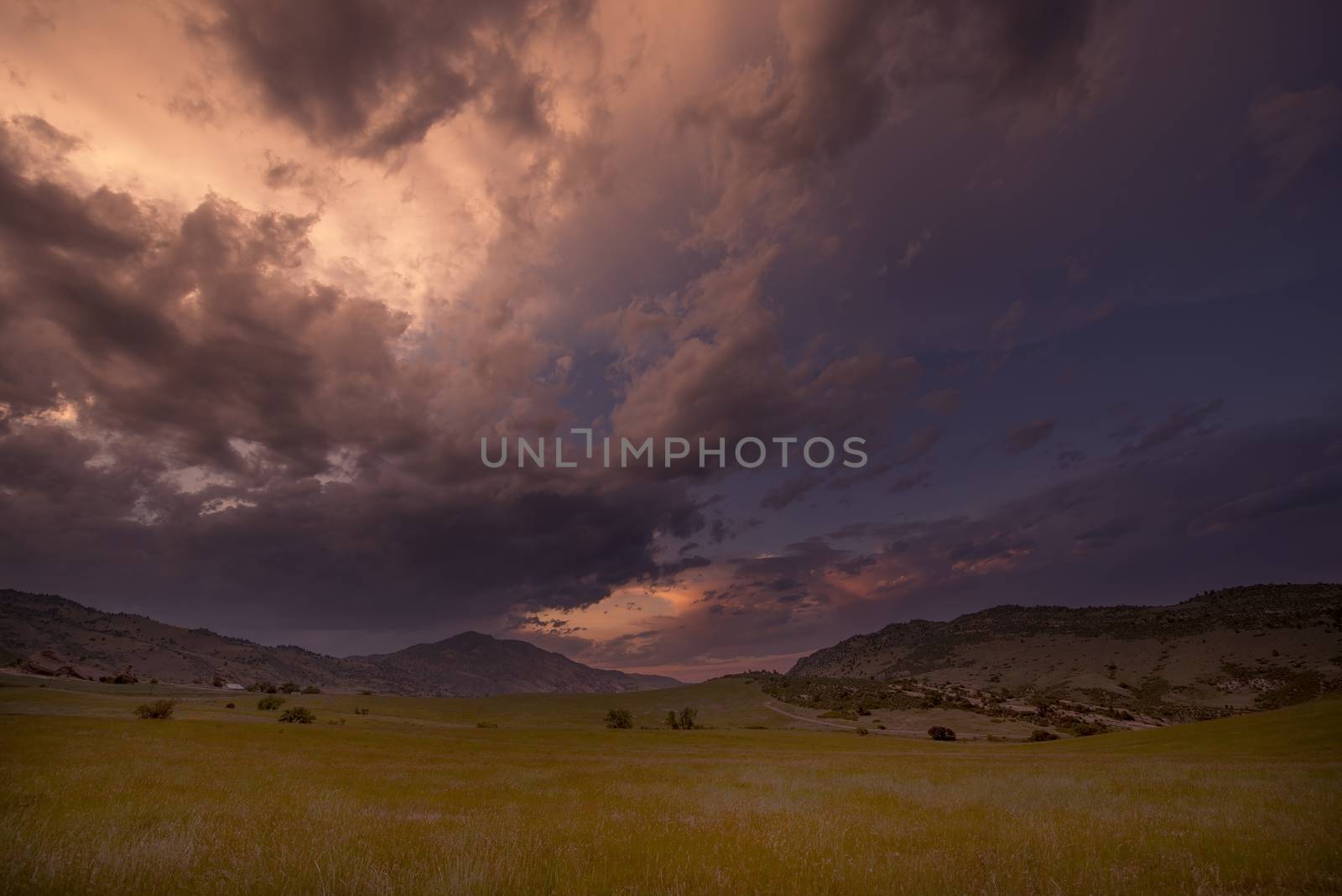 Red Rock Sunset Colorado. Front Range Rocky Mountains Sunset with Red Rocks Amphitheatre in a Distance.