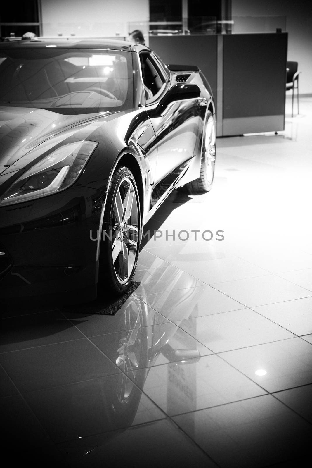 Luxury Super Car For Sale in Dealership Showroom. Black and White Color Grading.