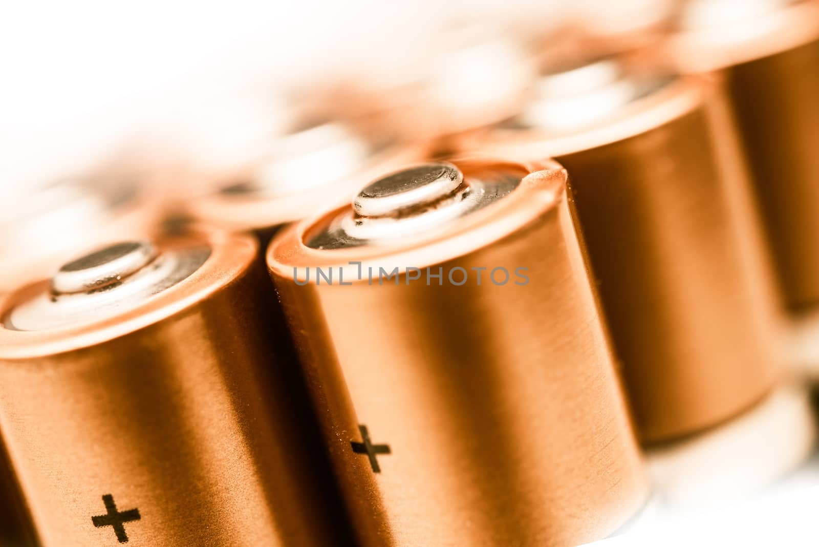 AA Batteries Closeup on a White Background. Batteries Technology. Power Industry.