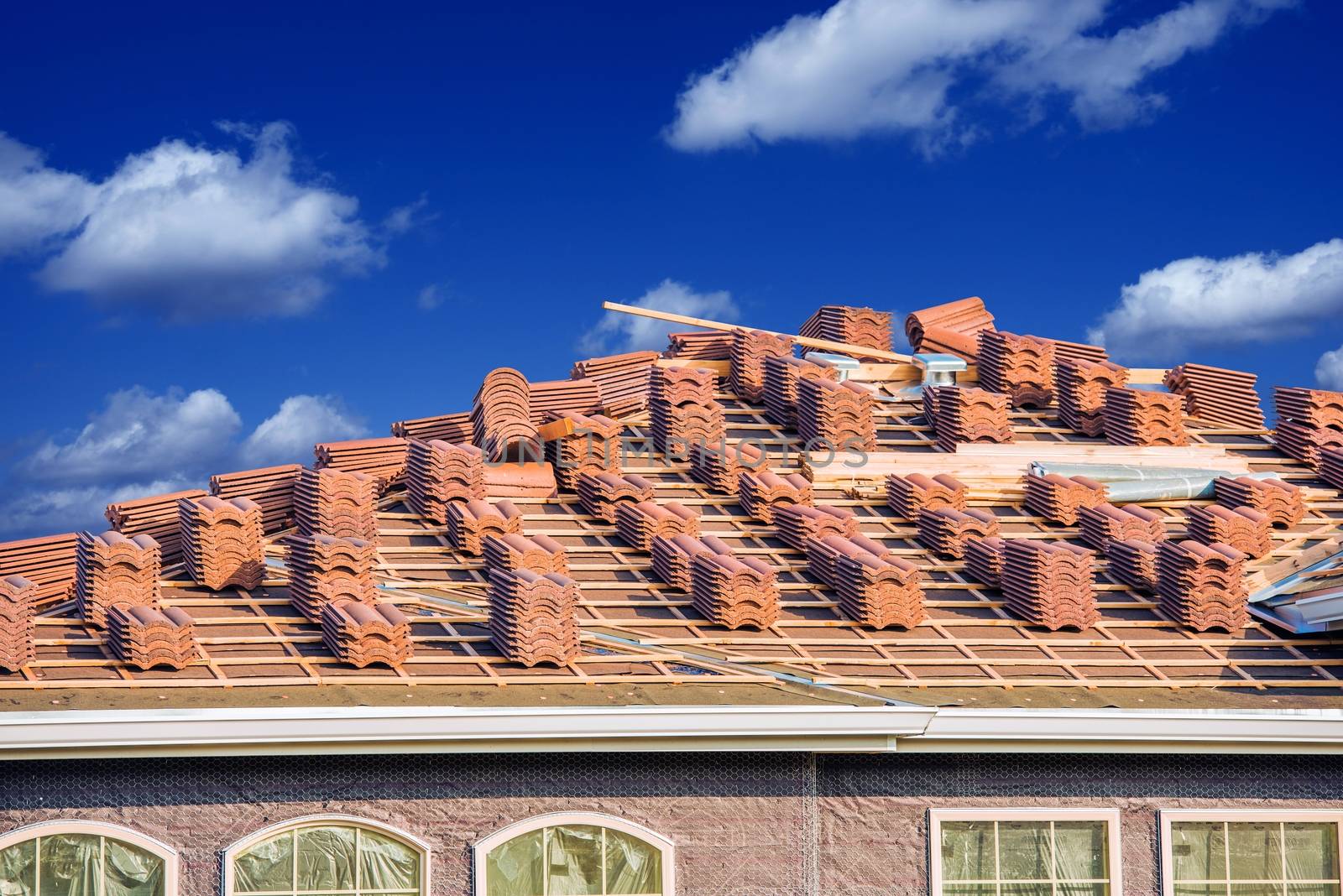 Ceramic Roof Slates Works. Residential Roof Closeup. Piles of Ceramic Roof Slates.