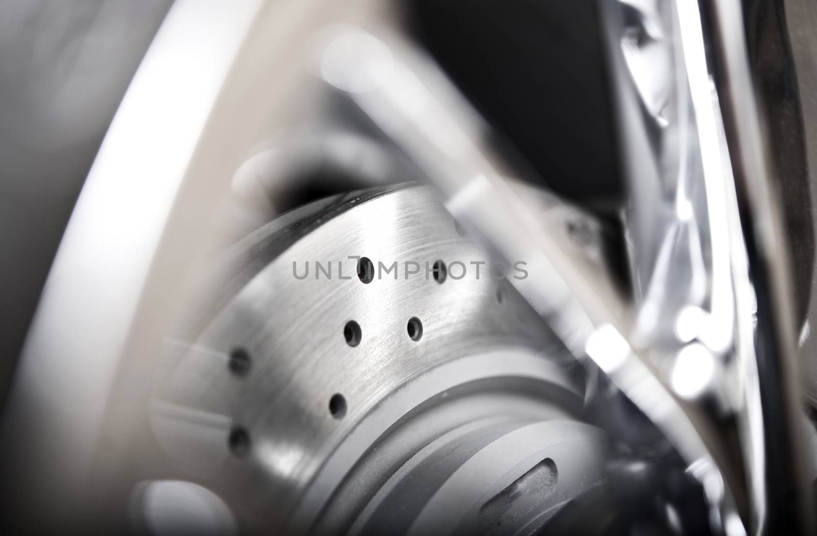 Ventilated Car Brake Disc and Alloy Wheel Closeup. Modern Car Wheel and Brakes.