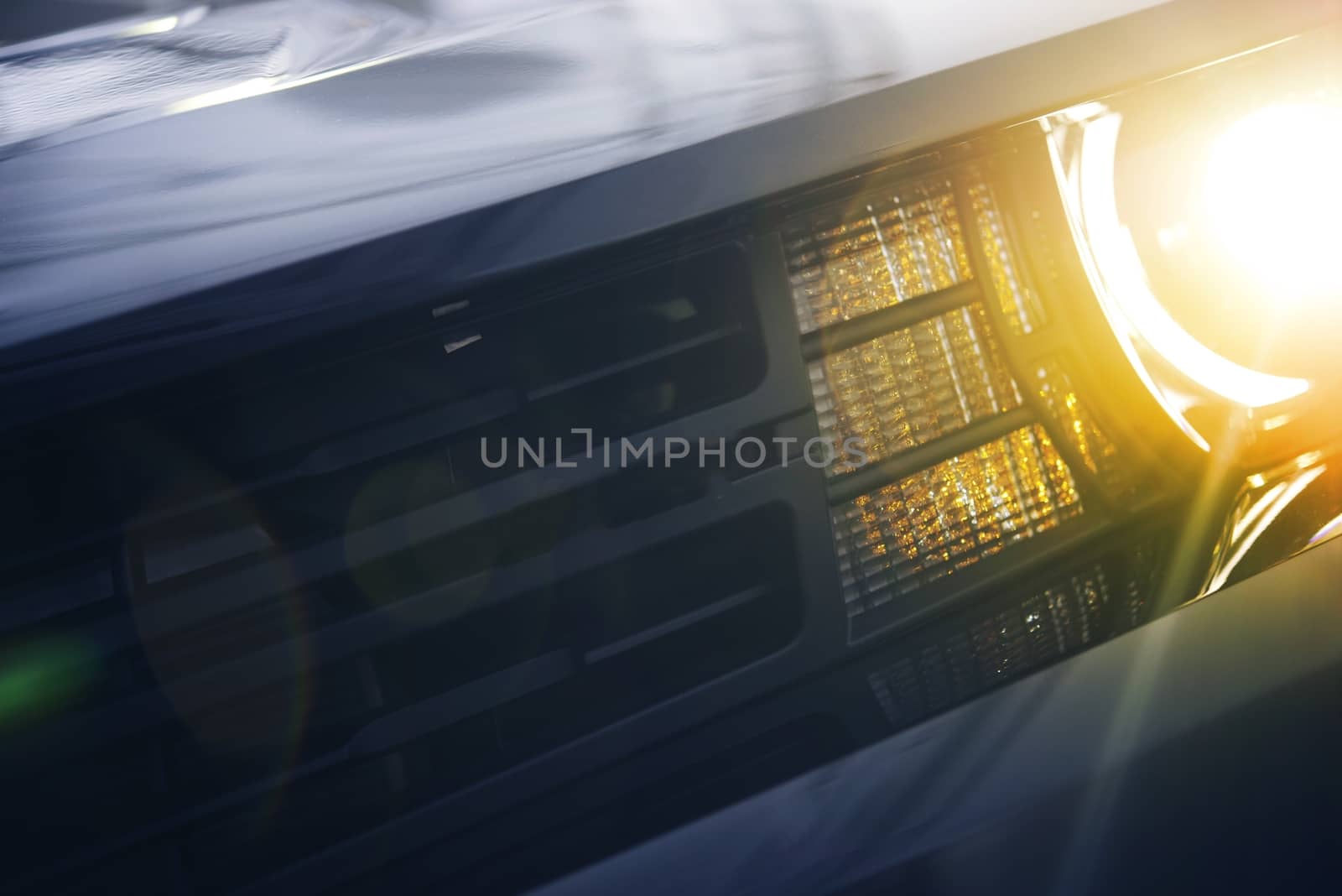 Car Bright Headlight and Grill Closeup Photo.