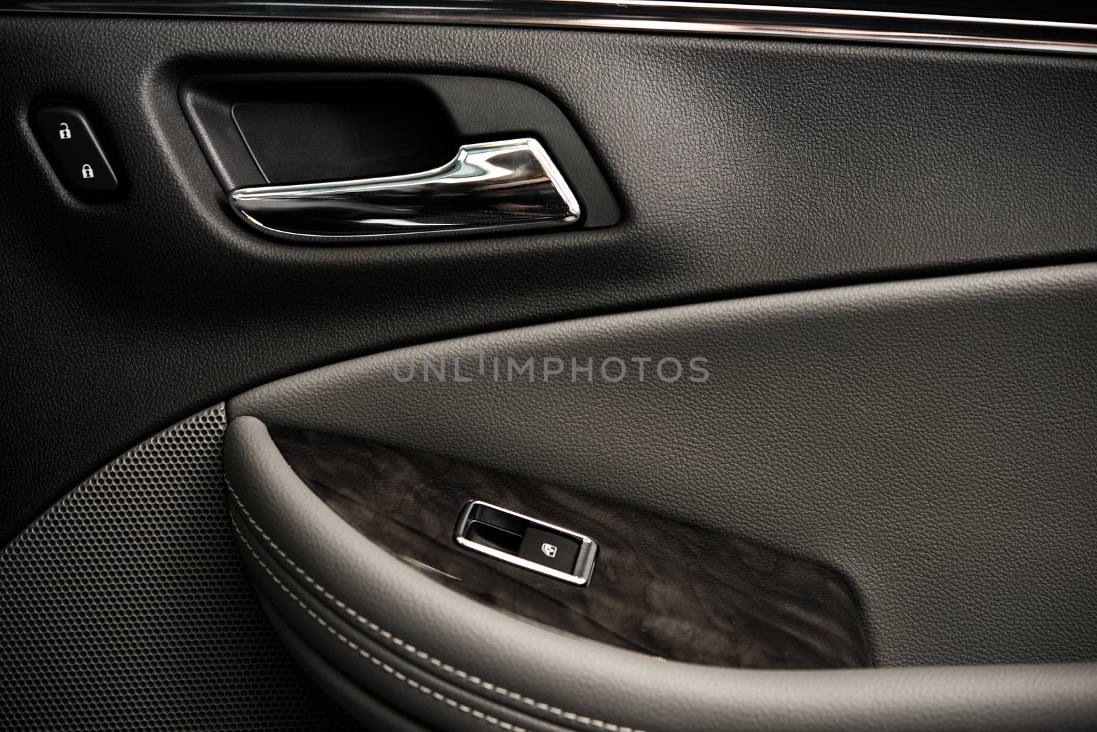 Luxury Car Door Closeup Photo. Leather, Chrome and High End Elements. Modern Car Interior Elements.