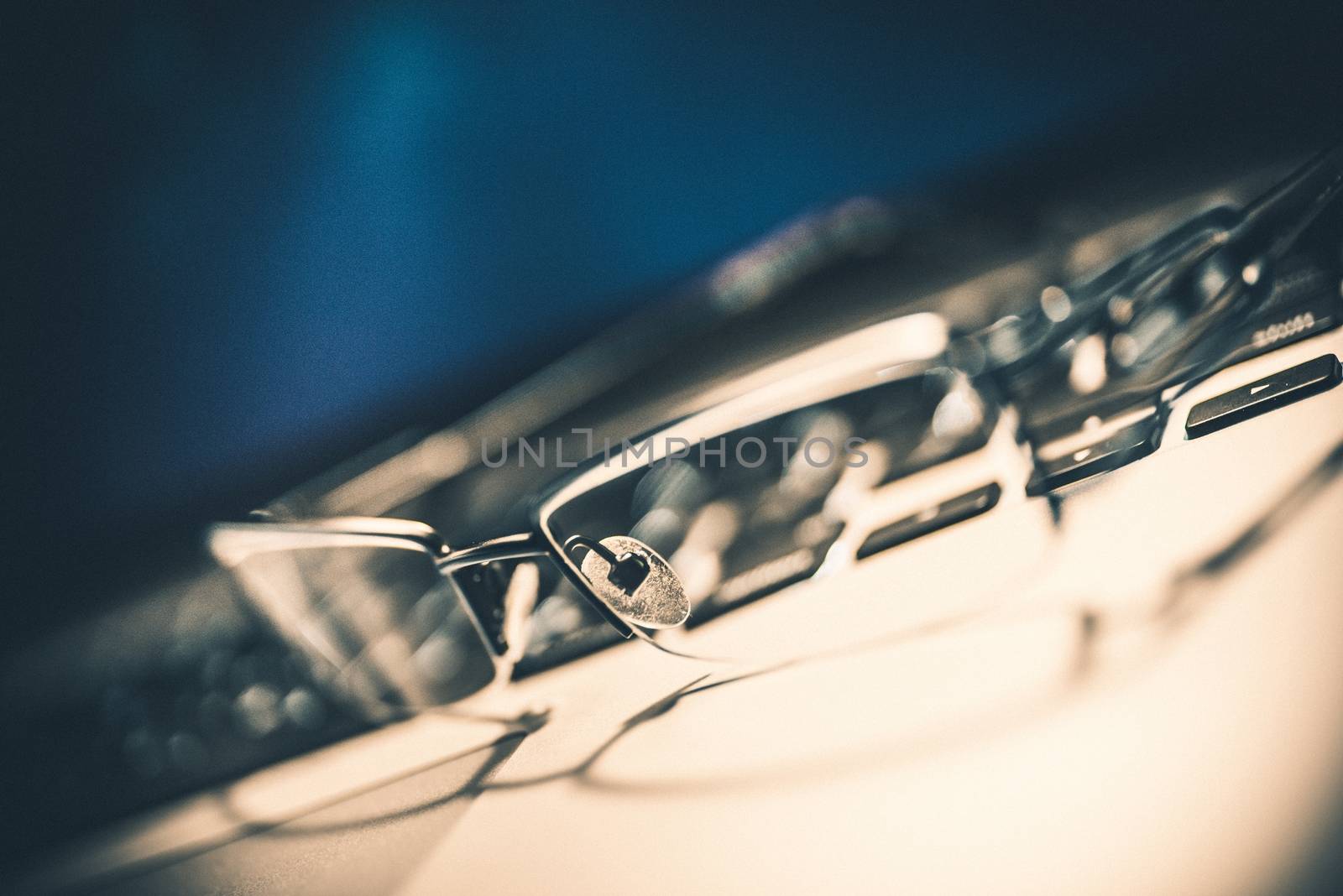 Glasses on the Laptop. Closeup Cinematic Grading with Noise. Working on the Computer with Vision Problems.