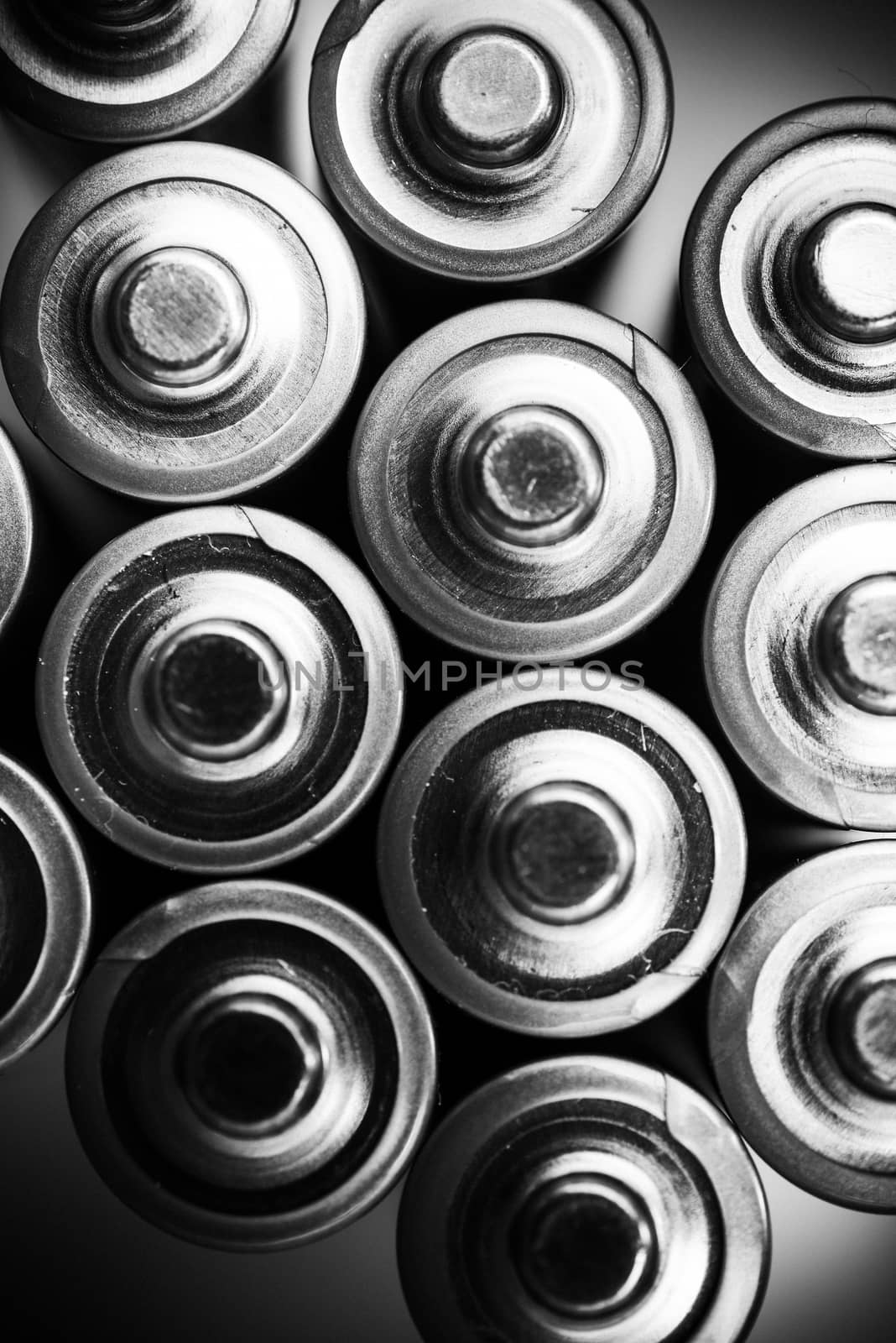 Energy Inside the Batteries. Mobile Power Industry Concept. AA Batteries From the Top. Vertical Black and White Photo