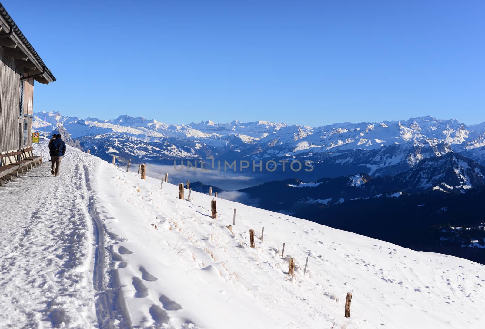 Snow walking path with snow mountains and blue sky; the Rigi Kulm in winter, Lucerne, Switzerland