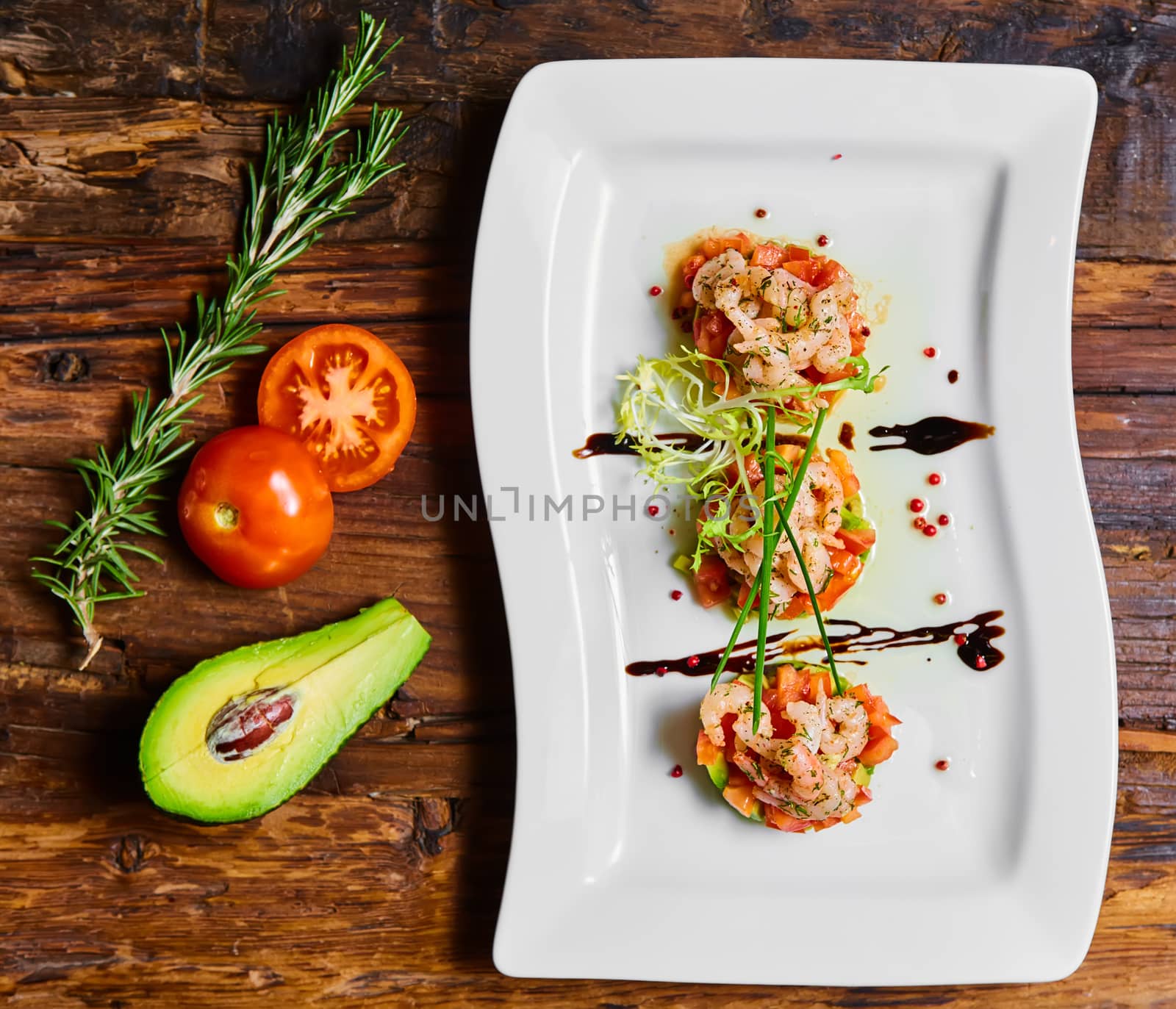 Salad with shrimps, tomato and avocado. Healthy food