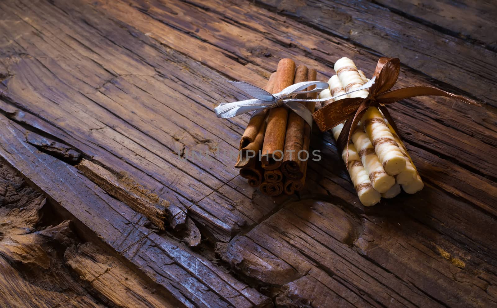 cinnamon sticks on brown wooden tables and red candles