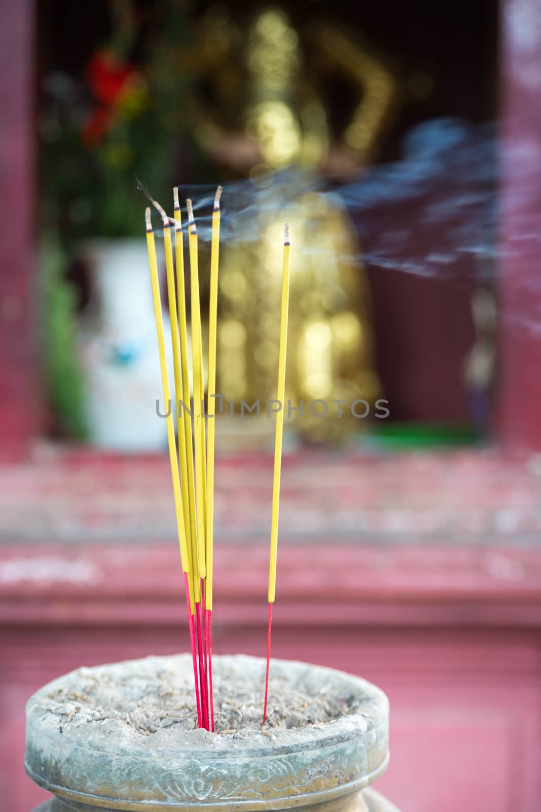 Burning joss sticks in pagoda, Saigon, Vietnam by fisfra
