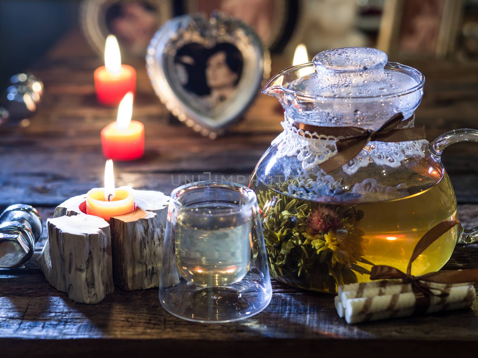 The exotic green tea with flowers in glass teapot  and cup