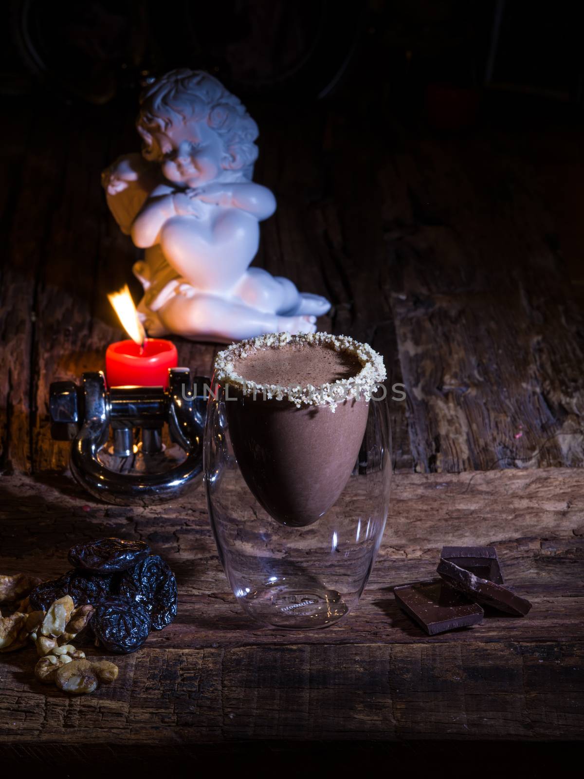 Cup of cacao with chocolate on wooden table