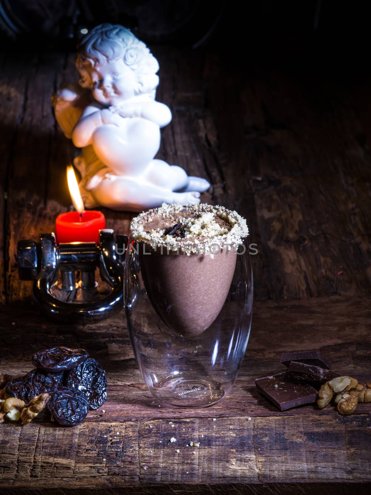 Cup of cacao with chocolate on wooden table