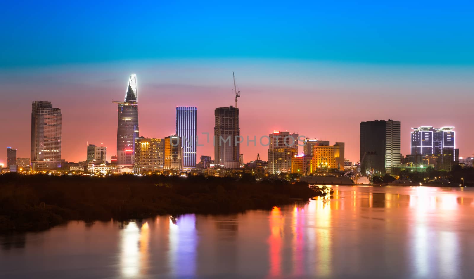 Saigon skyline with river after sunset, Vietnam by fisfra