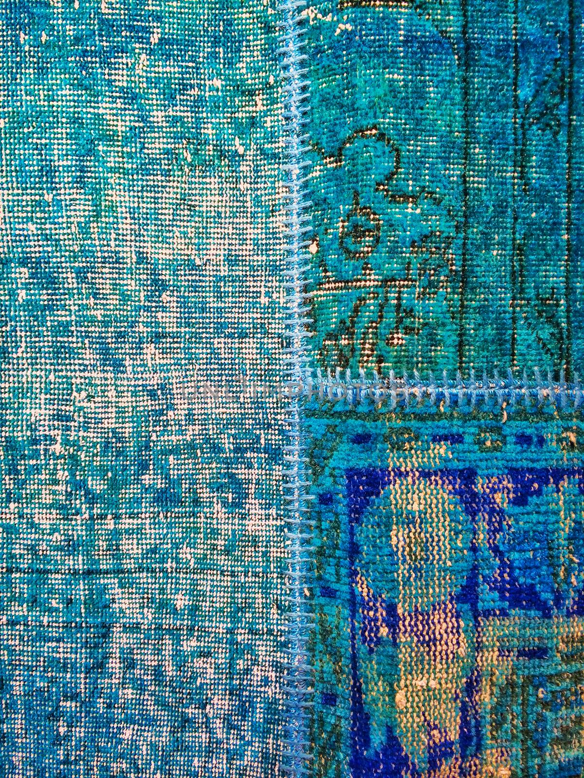 Vintage style blue patchwork rug with ethnic design.