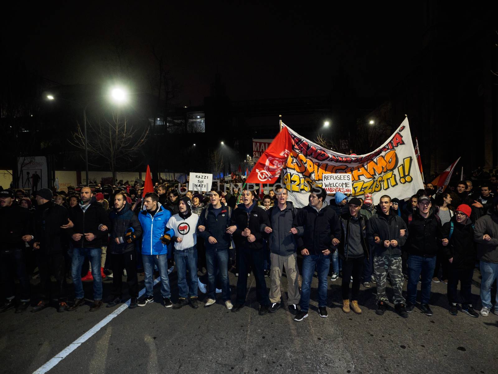 ITALY, Milan: Members of the Anti-Fascist Network of Milan march to protest against the meeting of Italian Secretary of the Northern League Matteo Salvini, French President of the National Front Marine Le Pen, and other officials at MiCo in Milan, Italy on January 28, 2016. Carrying pro-refugee signs, the protesters march through the city and launch fireworks.
