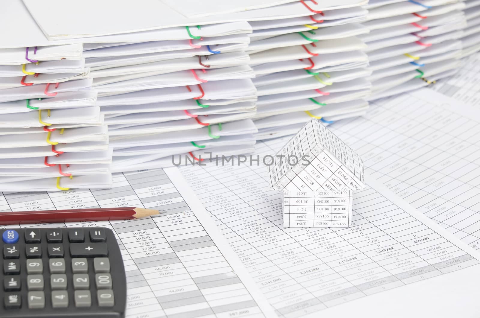 House with brown pencil and calculator on finance account by eaglesky