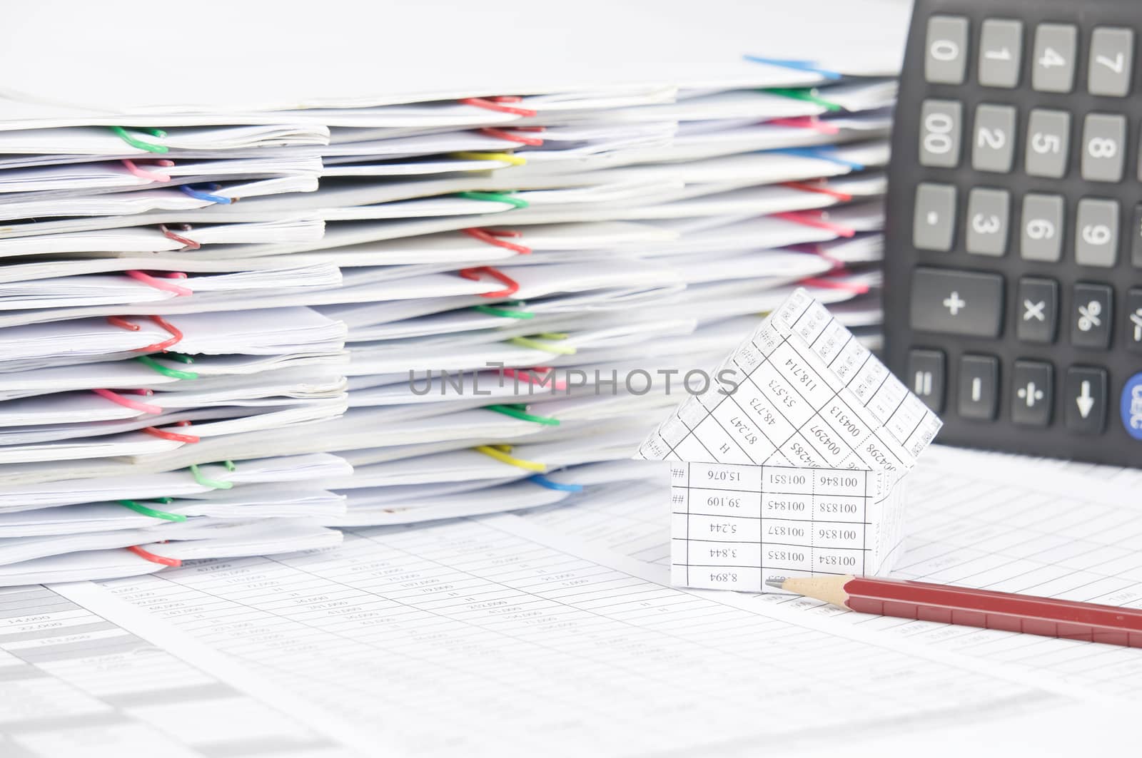 Pencil and house have pile of document with colorful paperclip by eaglesky