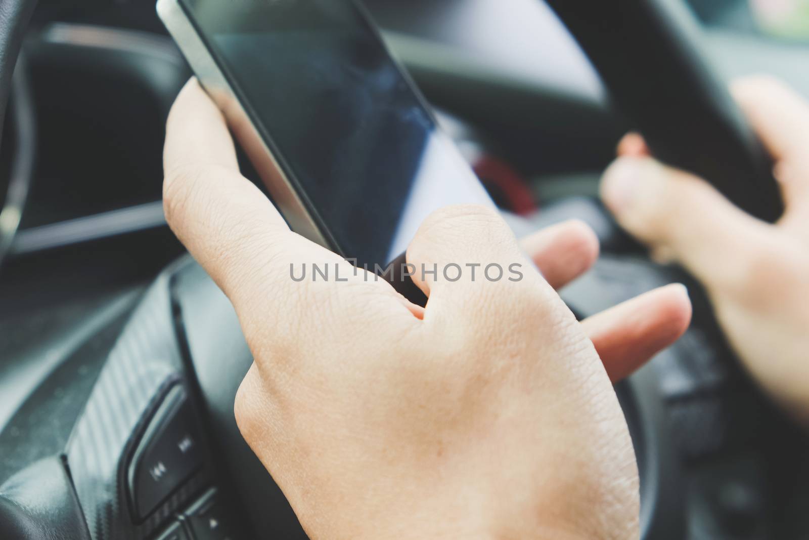 Image of using a mobile phone inside of a car