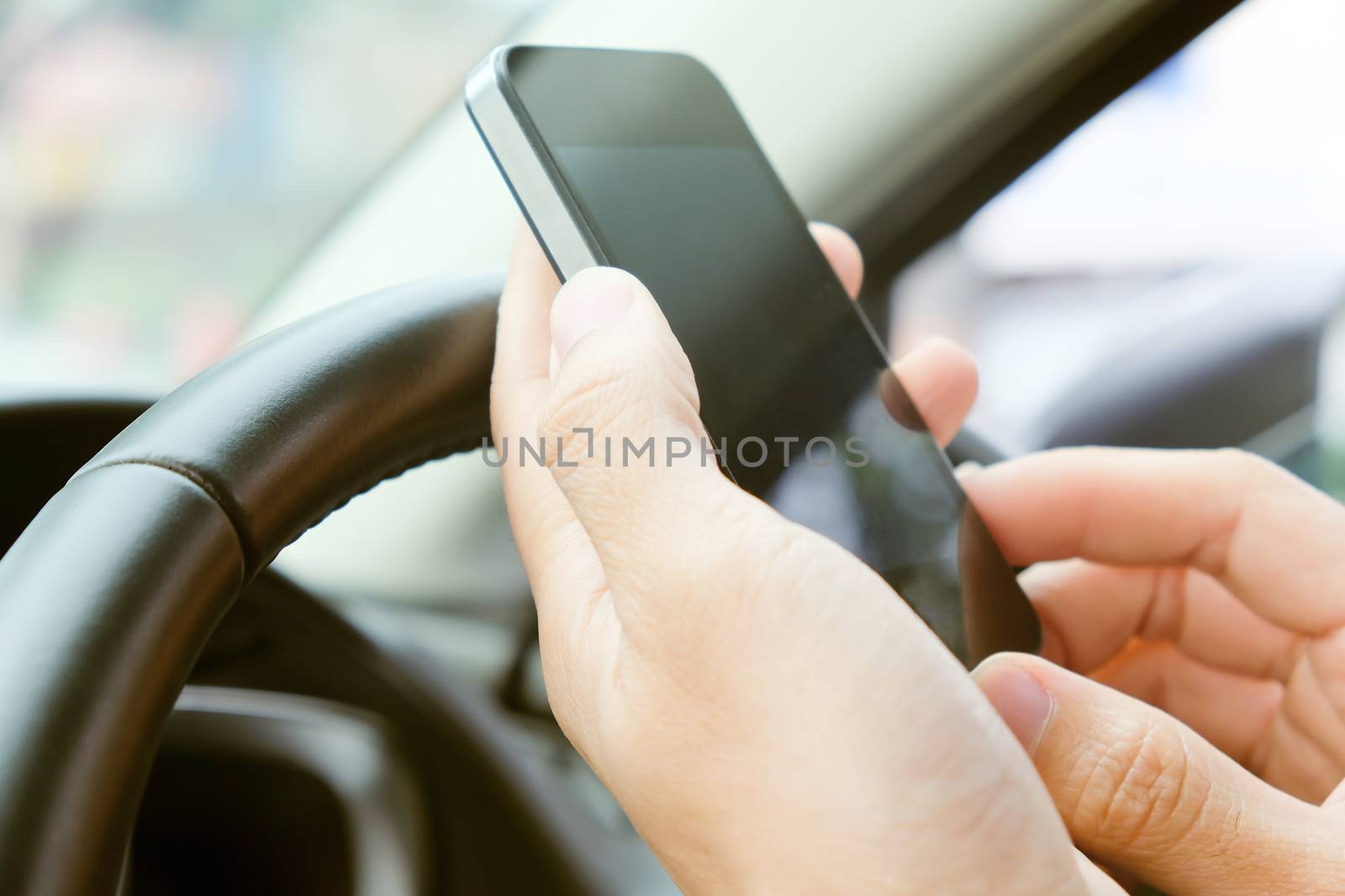 Image of using a mobile phone inside of a car