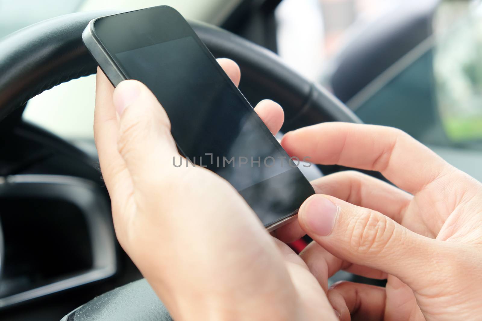 Image of using a mobile phone inside of a car