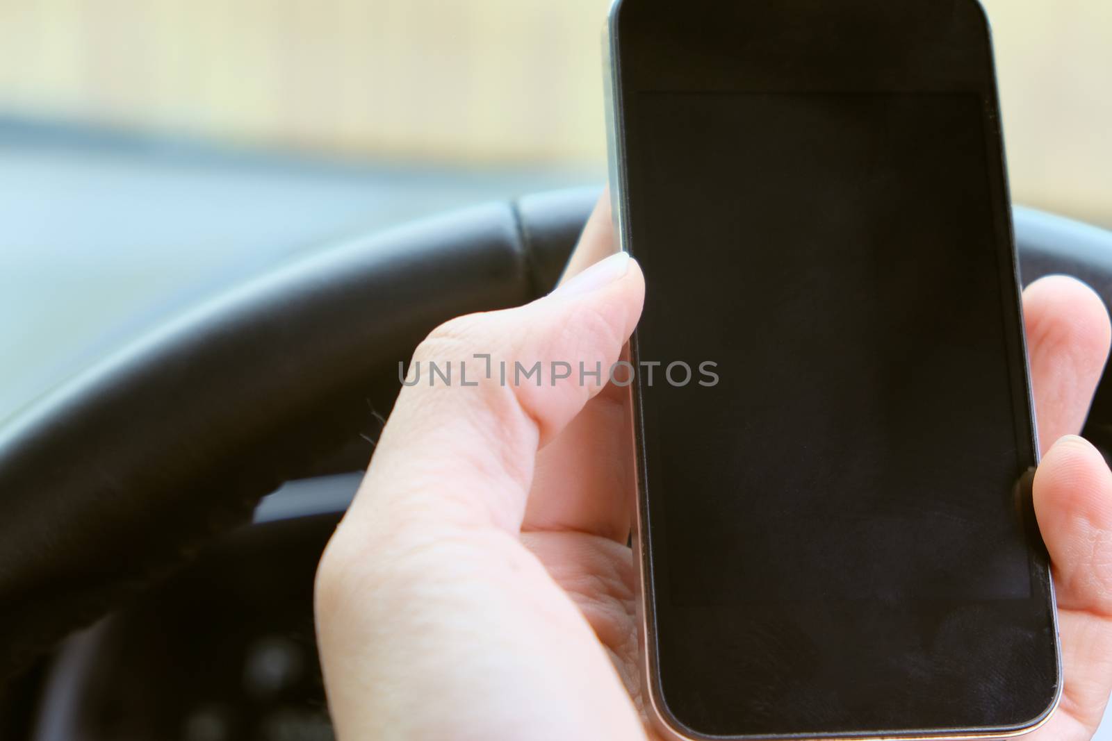 Image of using a mobile phone inside of a car