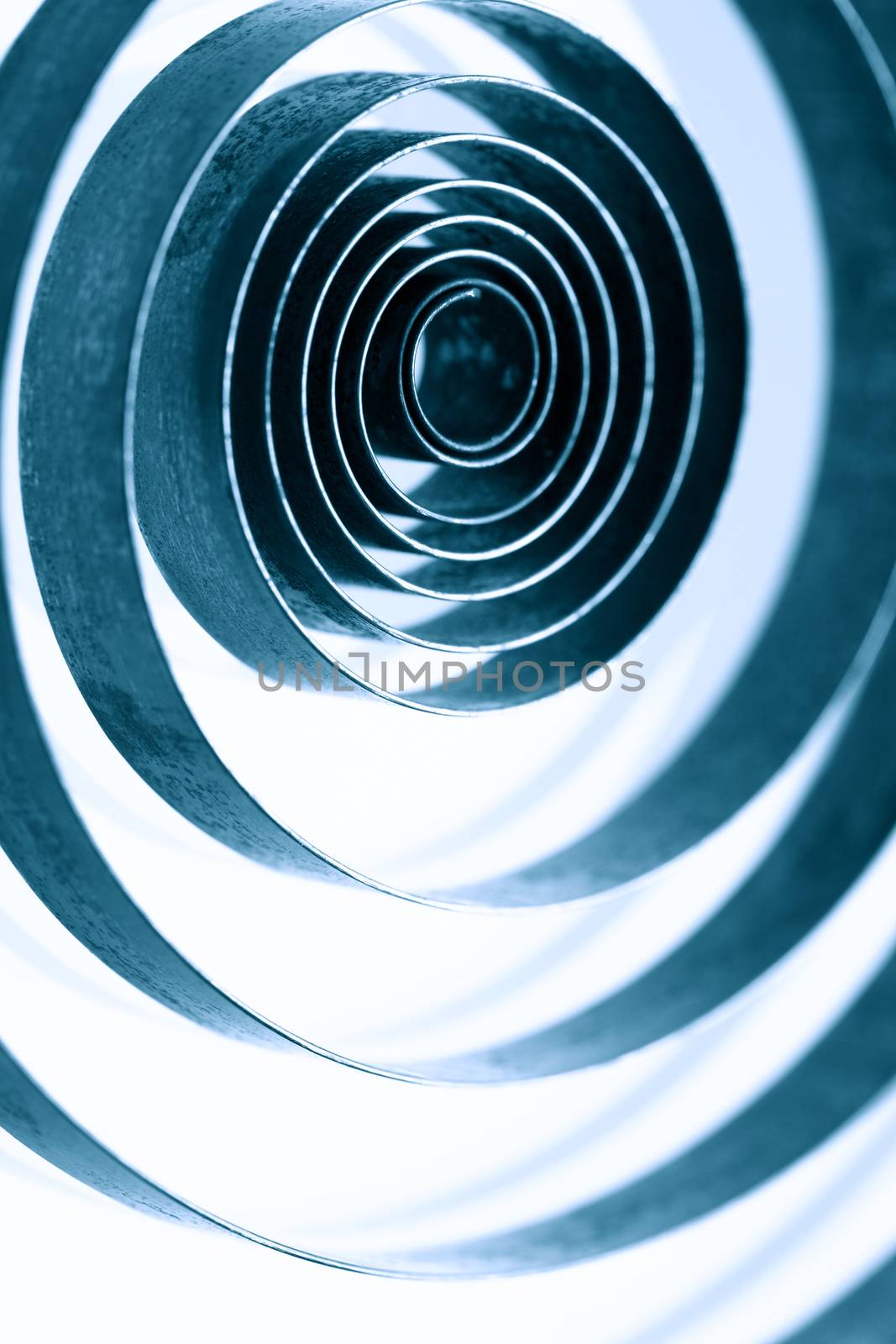 Industrial background. Closeup of old metal spiral on white background