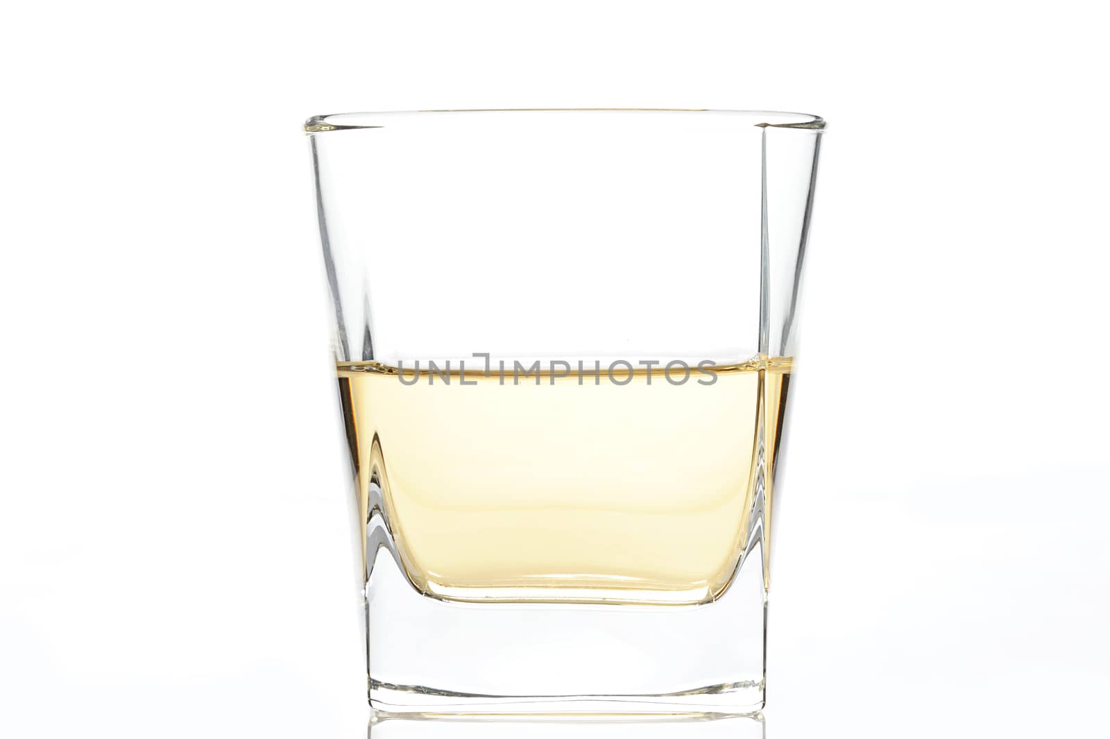 glass with a yellow rum on white background