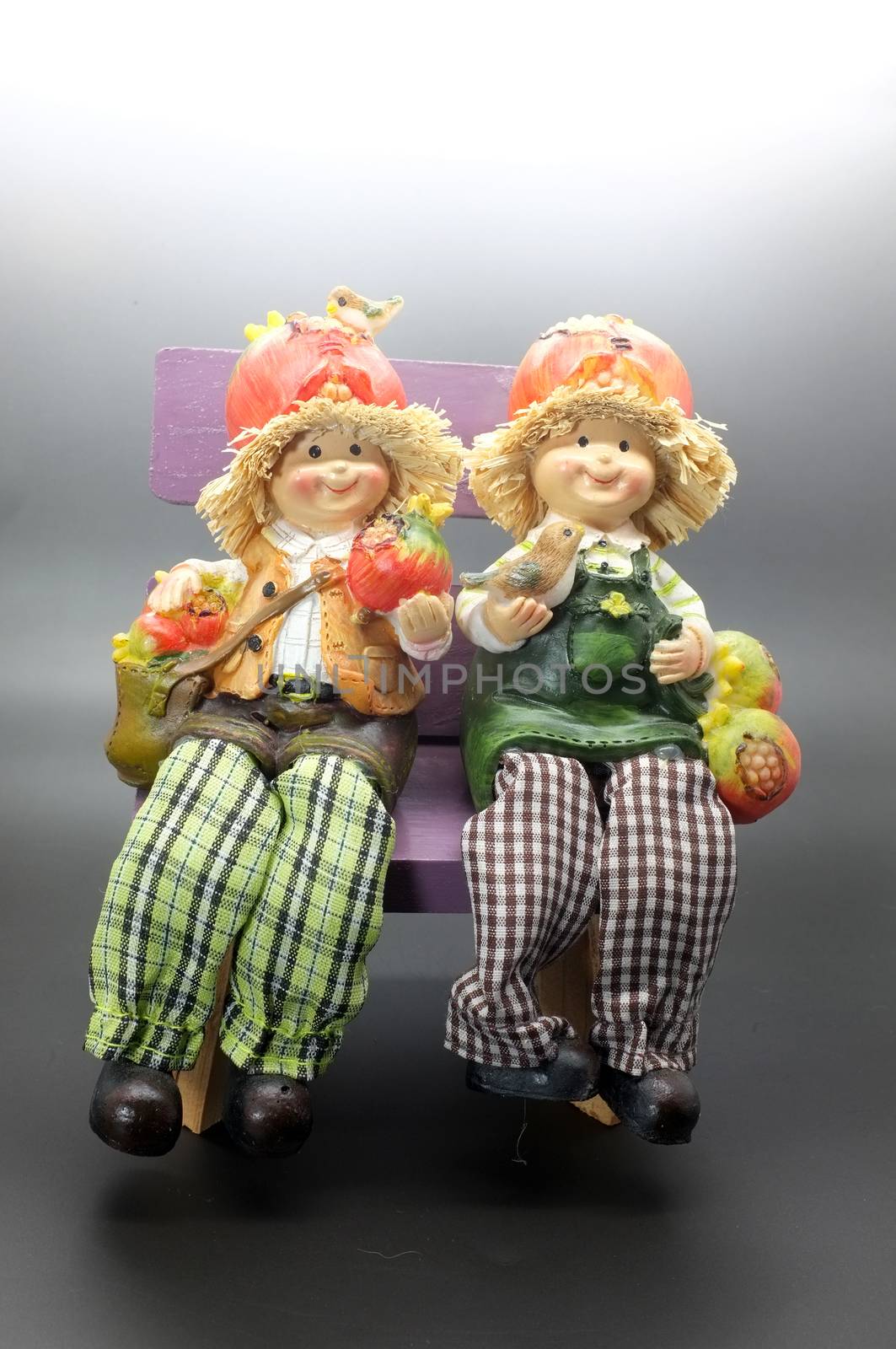 Vintage couple dolls sitting on chair