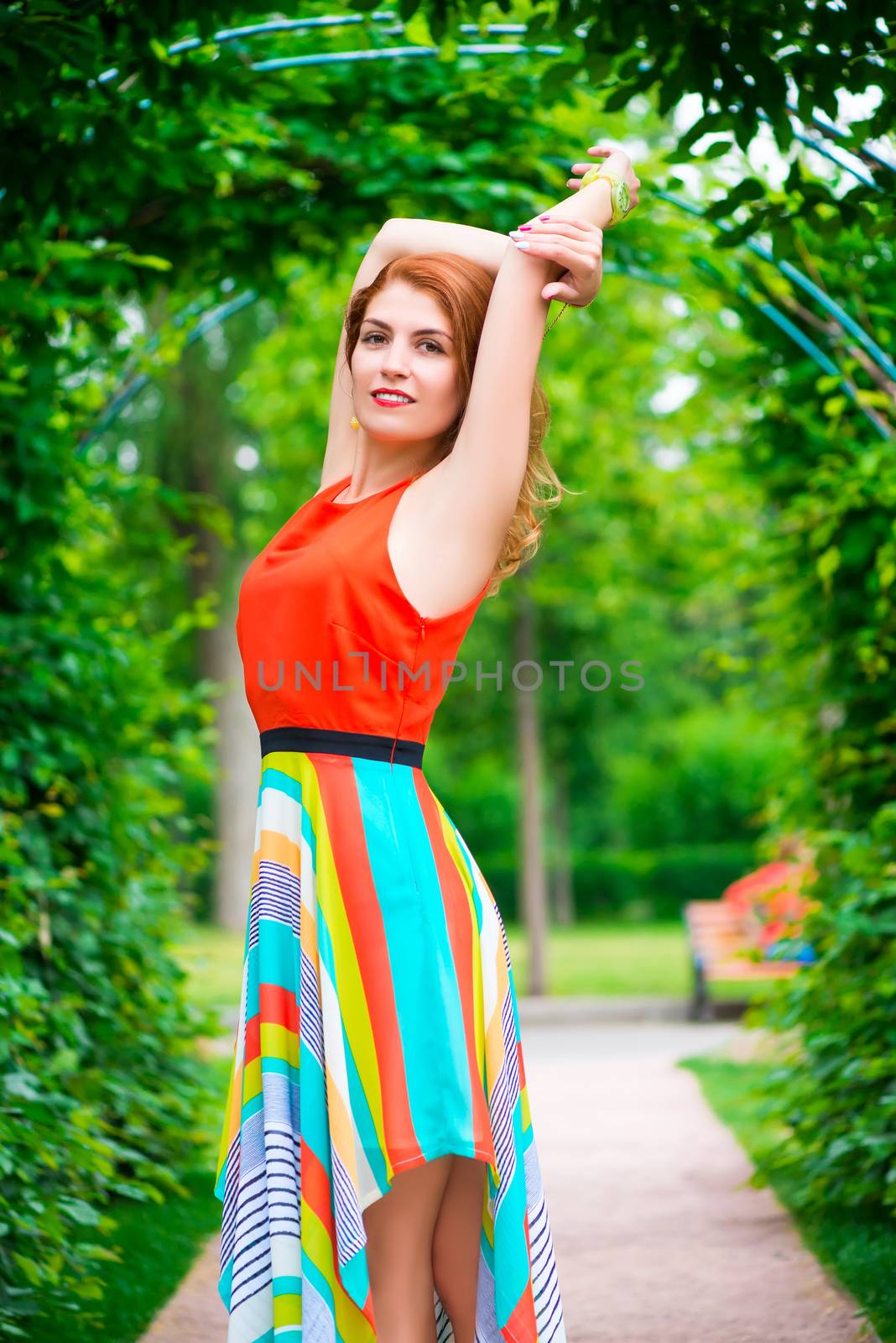 portrait of a girl in a green arch in the park