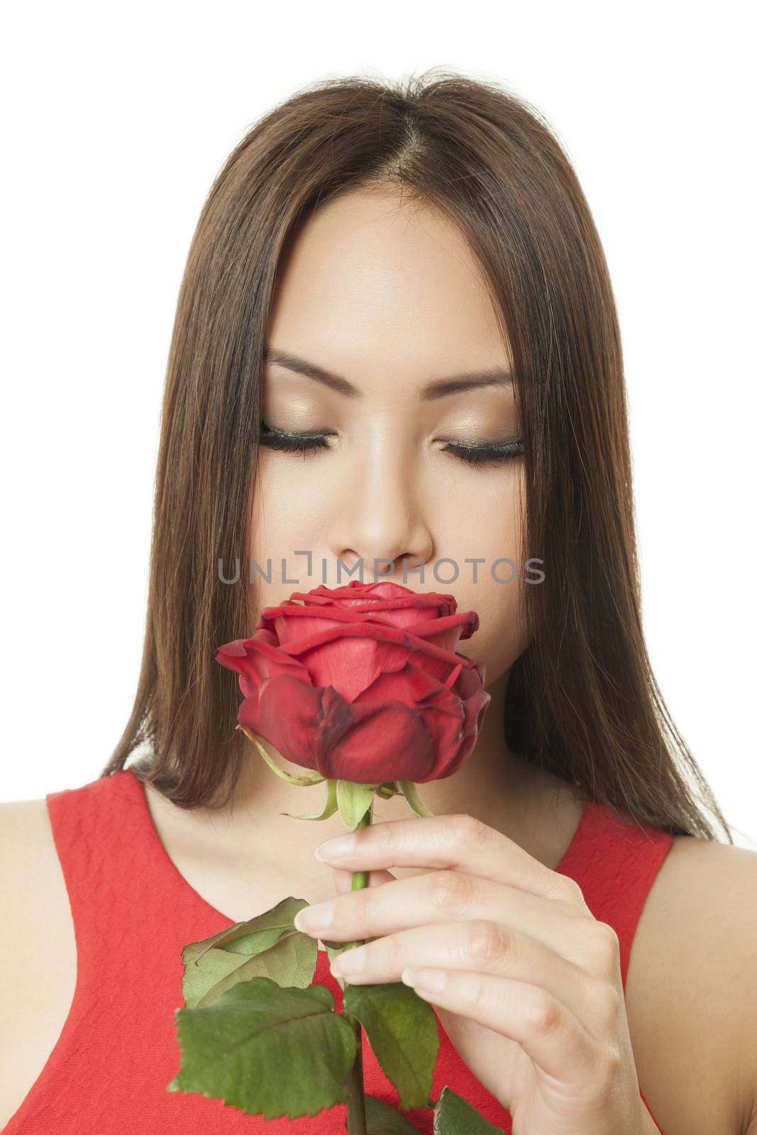 An asian woman with closed eyes and a red rose