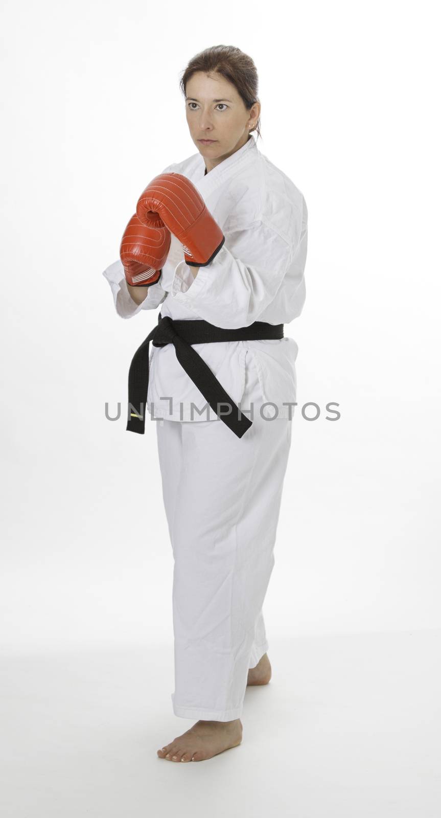woman wearing a karate uniform and red boxing glove