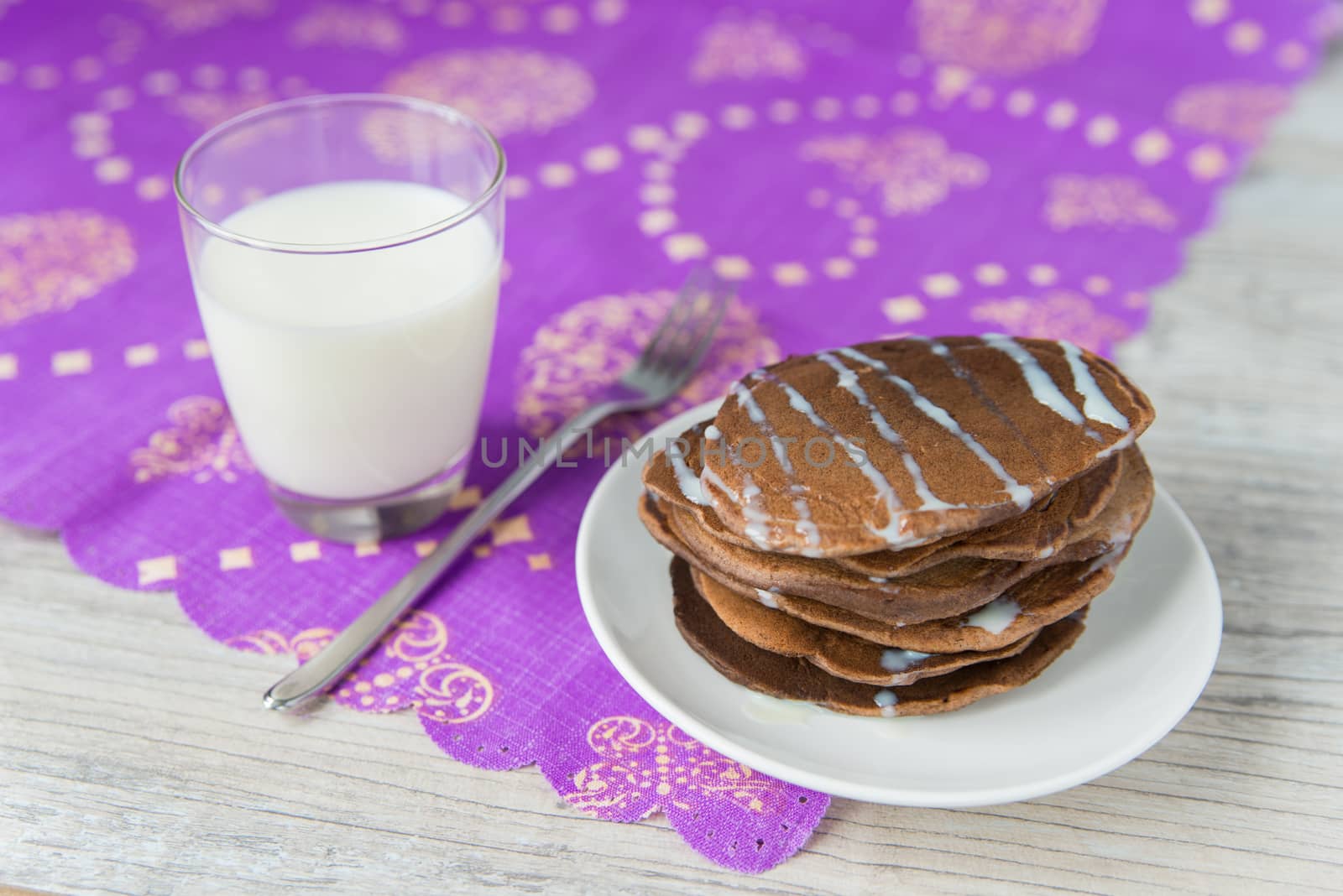 Chocolate pancakes with the glass of milk