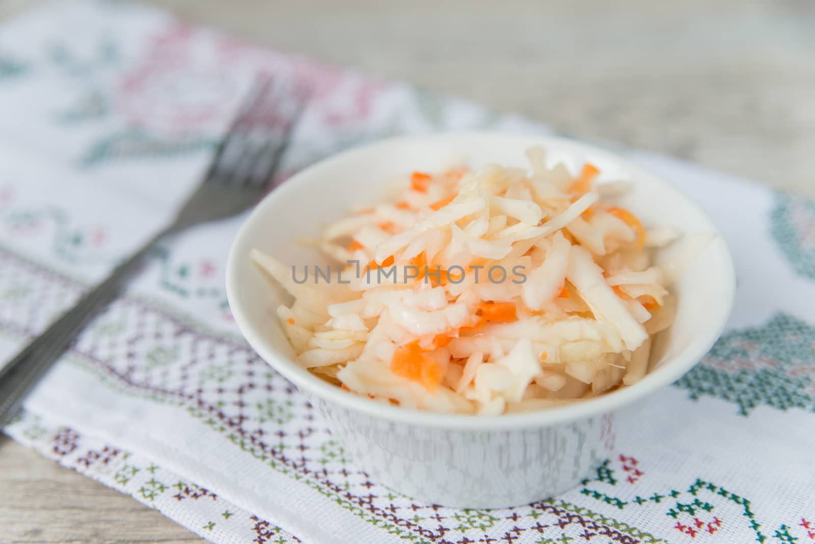 Plate with the sauerkraut on the napkin