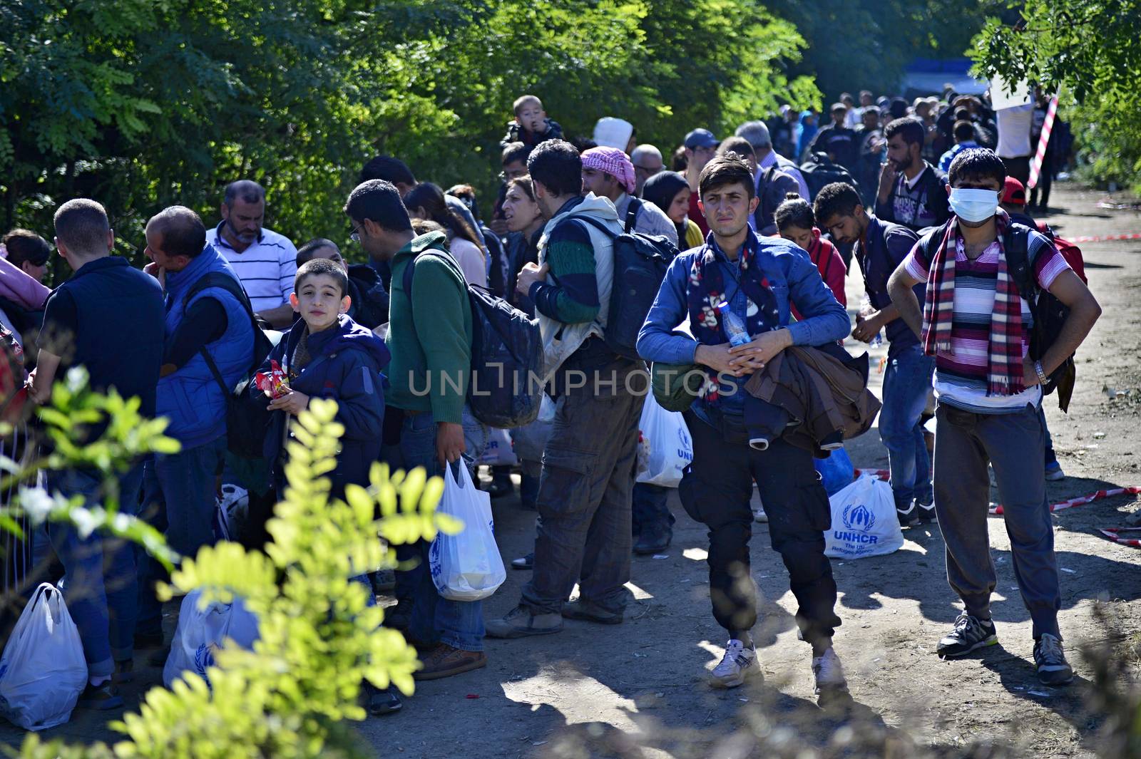 October 4, 2015; Bapska in Serbia. Group of refugees leaving Serbia. They came to Bapska by buses and then they leaving Serbia and go to Croatia and then to Germany. Many of them escapes from home because of civil war. 