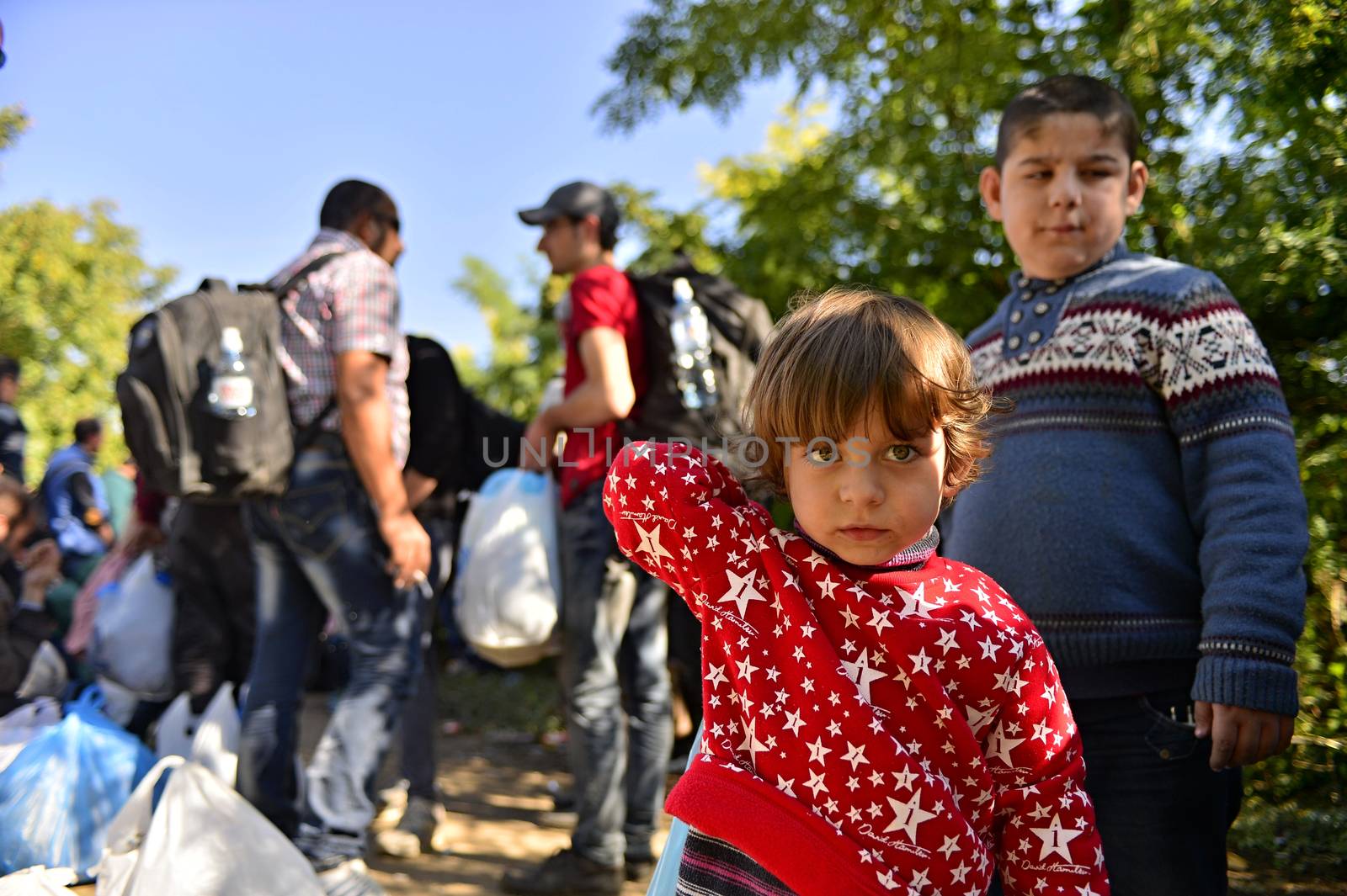 October 4, 2015; Bapska in Serbia. Group of refugees leaving Serbia. They came to Bapska by buses and then they leaving Serbia and go to Croatia and then to Germany. Many of them escapes from home because of civil war. 