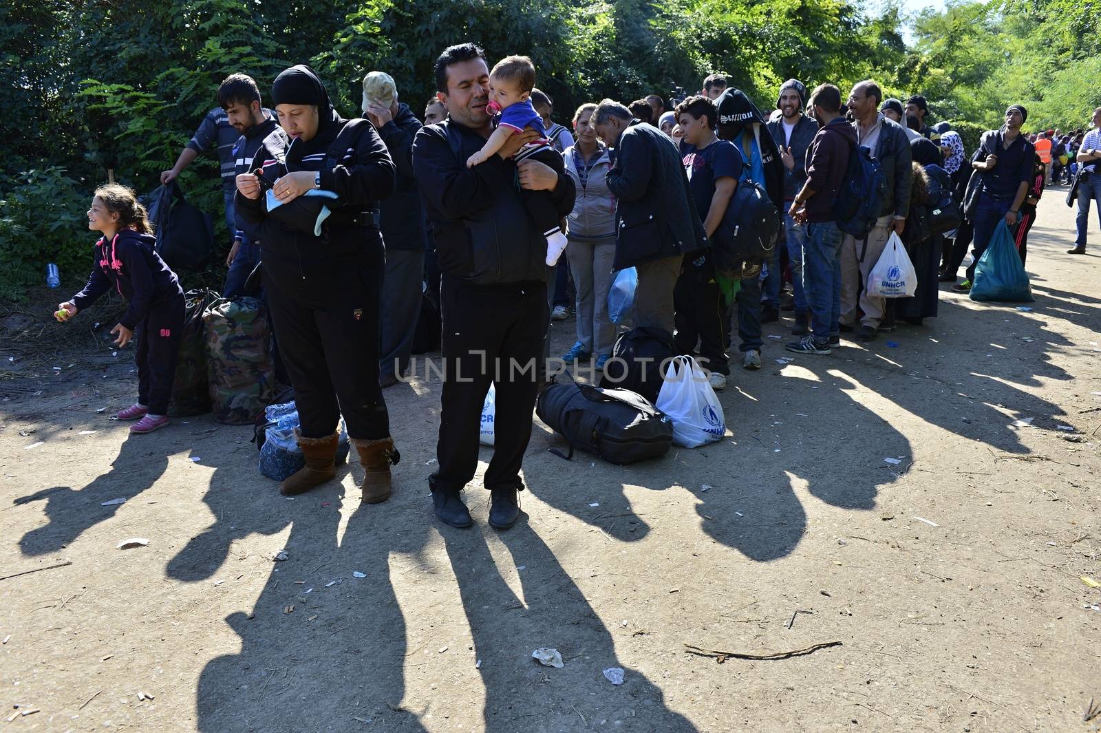 October 4, 2015; Bapska in Serbia. Group of refugees leaving Serbia. They came to Bapska by buses and then they leaving Serbia and go to Croatia and then to Germany. Many of them escapes from home because of civil war. 