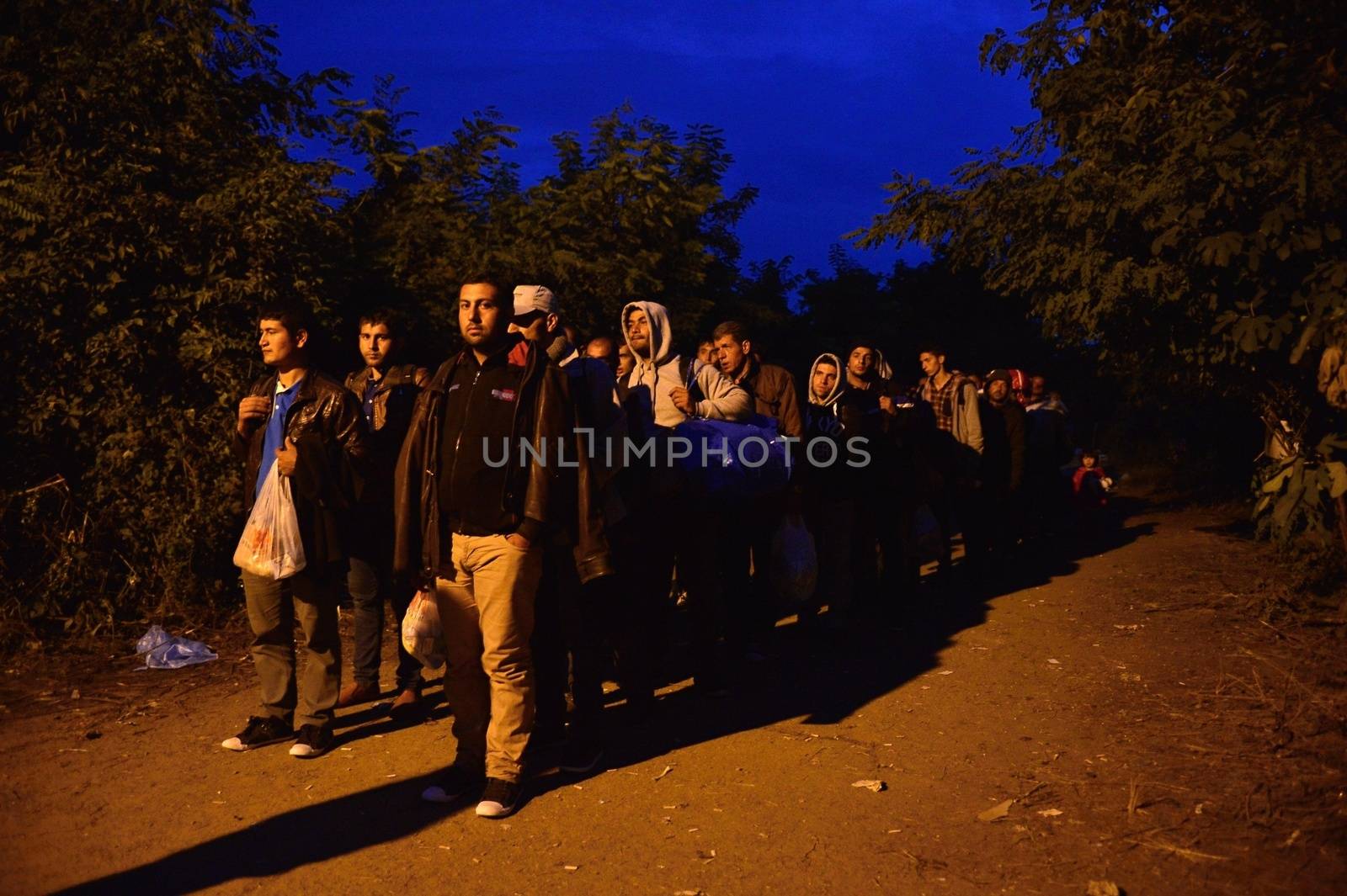 October 4, 2015; Bapska in Serbia. Group of refugees leaving Serbia. They came to Bapska by buses and then they leaving Serbia and go to Croatia and then to Germany. Many of them escapes from home because of civil war. 