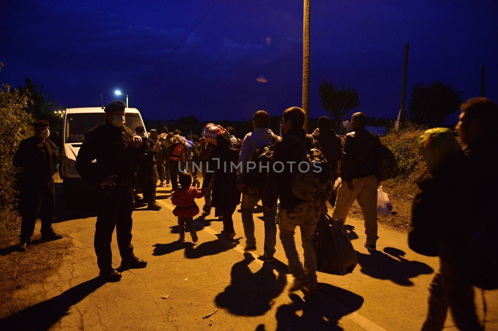 October 4, 2015; Bapska in Serbia. Group of refugees leaving Serbia. They came to Bapska by buses and then they leaving Serbia and go to Croatia and then to Germany. Many of them escapes from home because of civil war. 