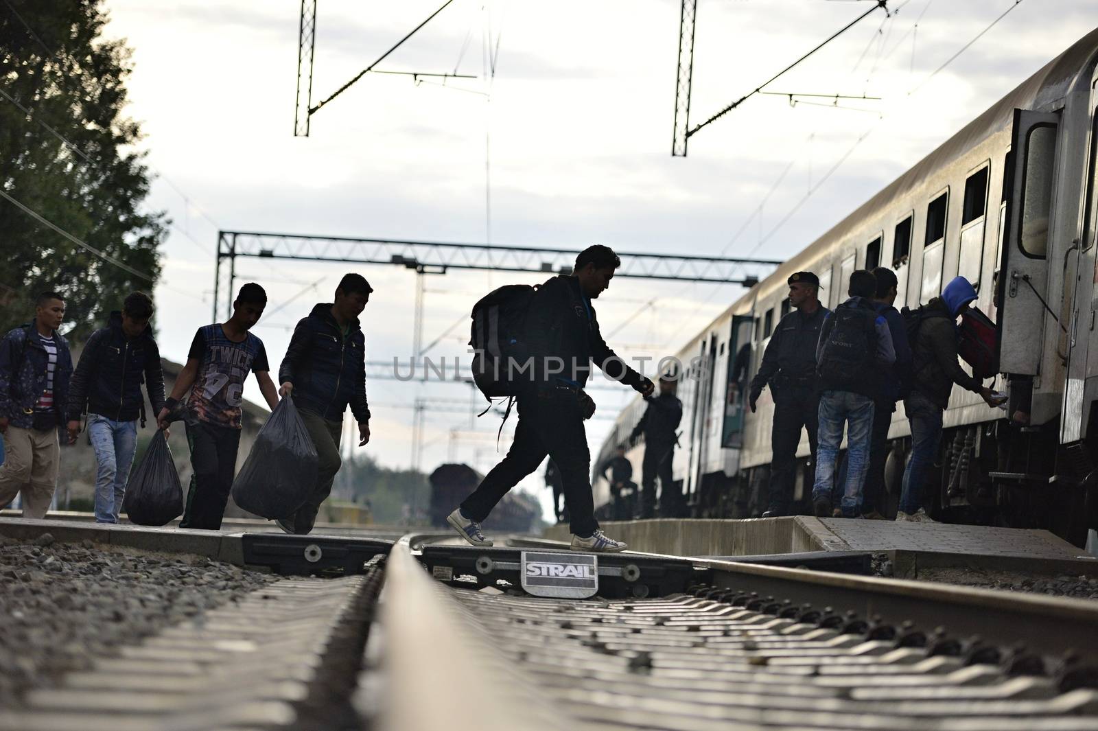 October 5, 2015; Tovarnik in Croatia. Croatian police assist refugees get into train which will go to Hungary.