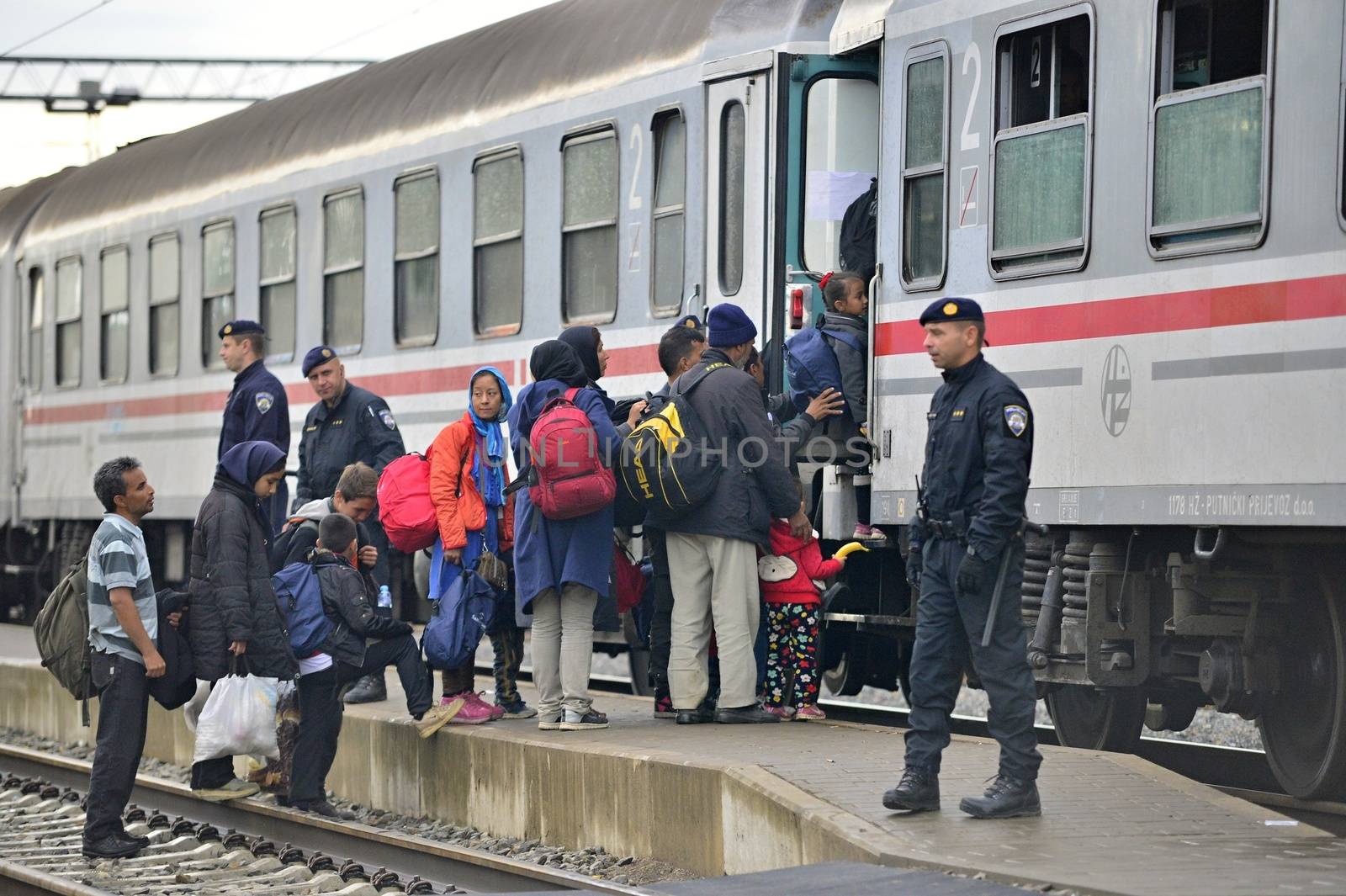 October 5, 2015; Tovarnik in Croatia. Croatian police assist refugees get into train which will go to Hungary.