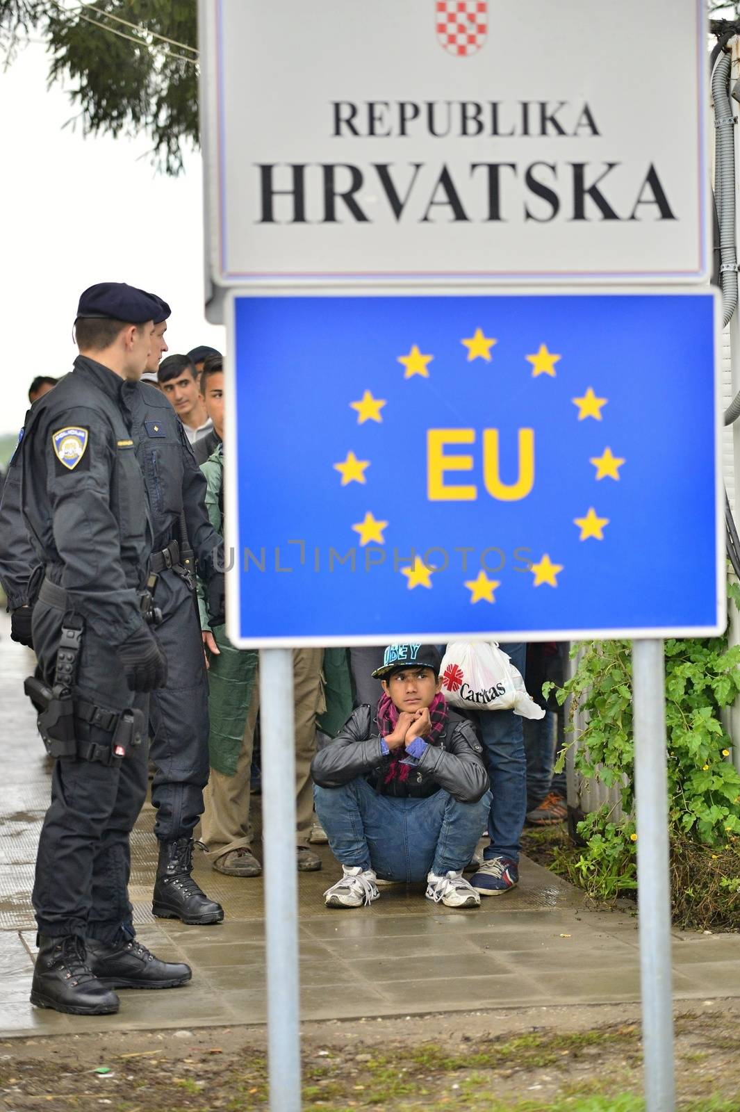 October 5, 2015; Tovarnik in Croatia. Croatian police assist refugees get into train which will go to Hungary.