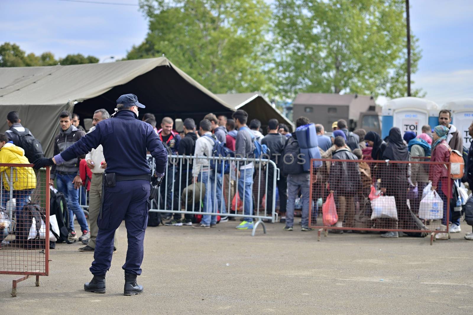 October 5, 2015; Tovarnik in Croatia. Croatian police assist refugees get into train which will go to Hungary.