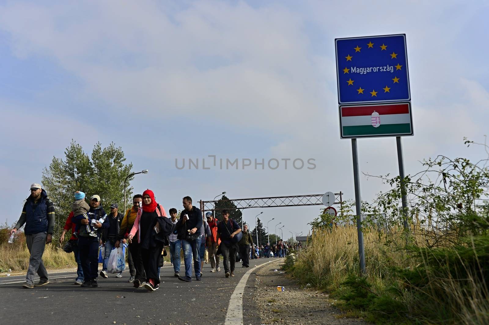 October 6,2015; Hegyeshalom in Hungary. Group of refugees leaving Hungary. They came to Hegyeshalom by train and then they leaving Hungary and go to Austria and then to Germany. Many of them escapes from home because of civil war. 