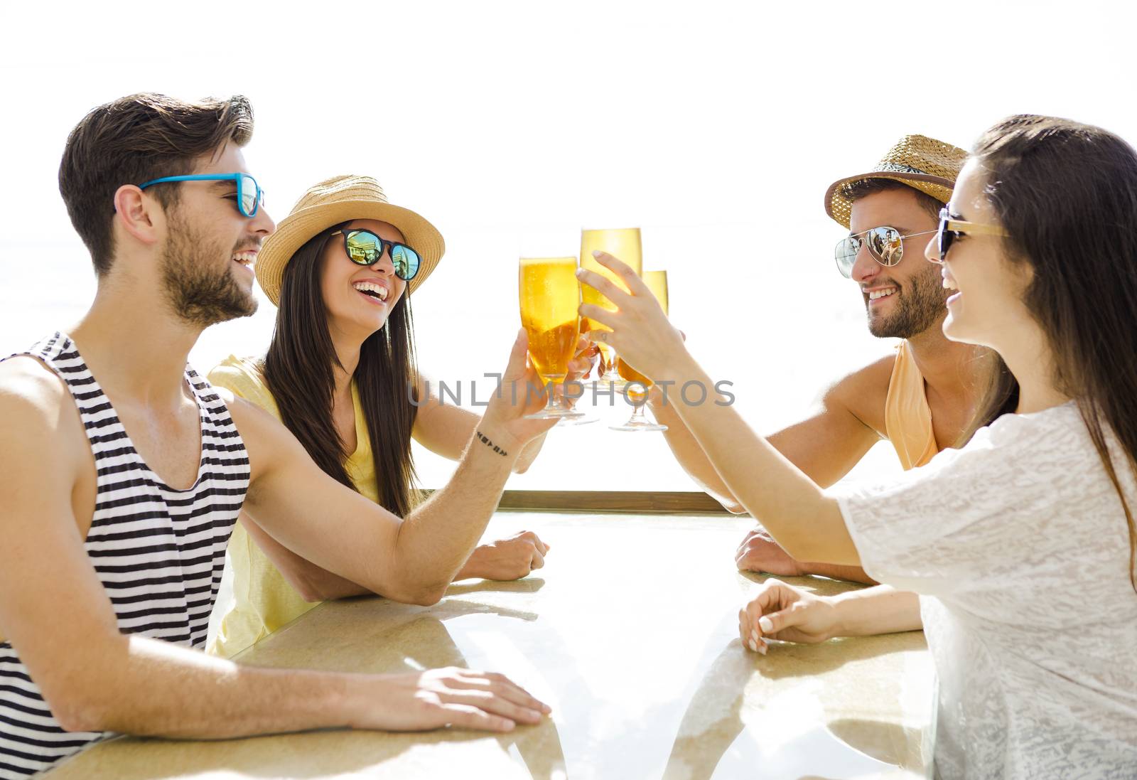Friends drinking a cold beer by Iko